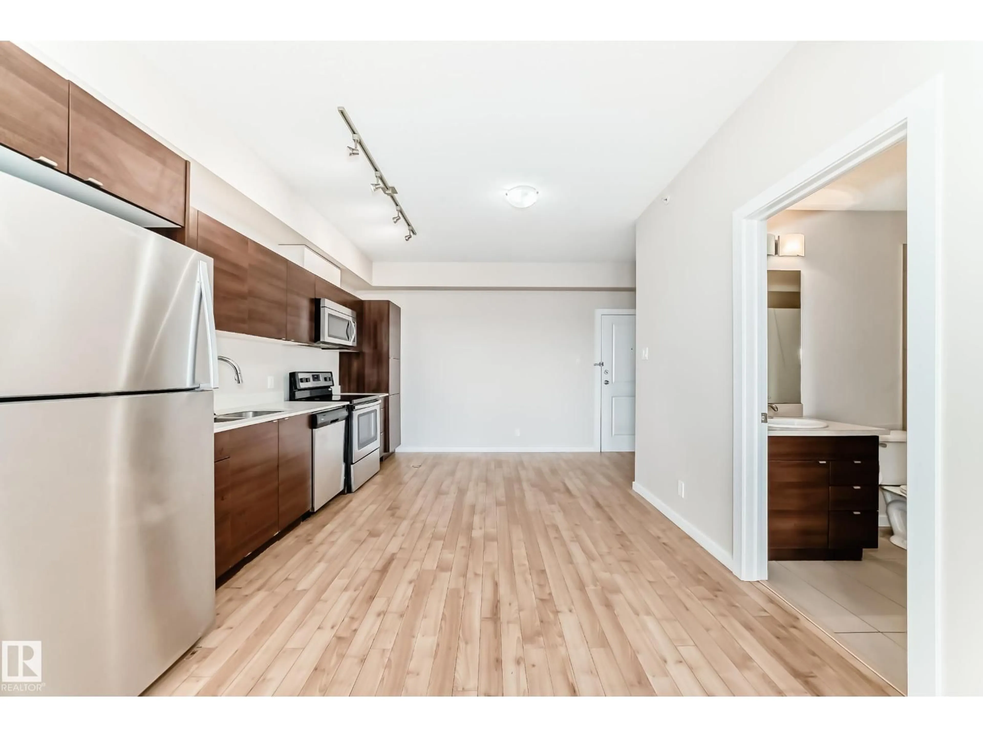 Open concept kitchen, wood/laminate floor for #413 - 9519 160 AV, Edmonton Alberta T5Z0N1
