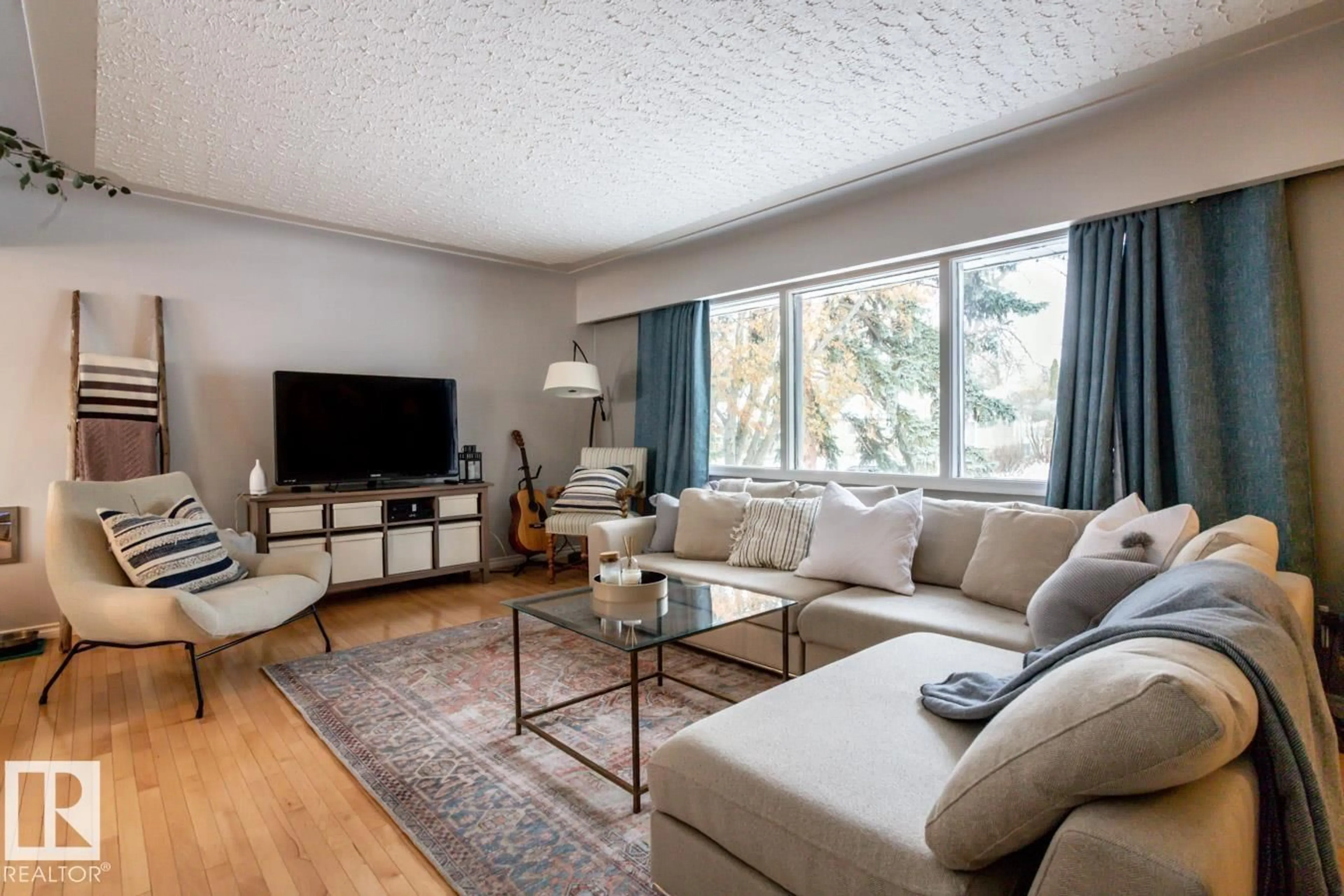 Living room with furniture, wood/laminate floor for 8239 93A AV, Edmonton Alberta T6C1V5