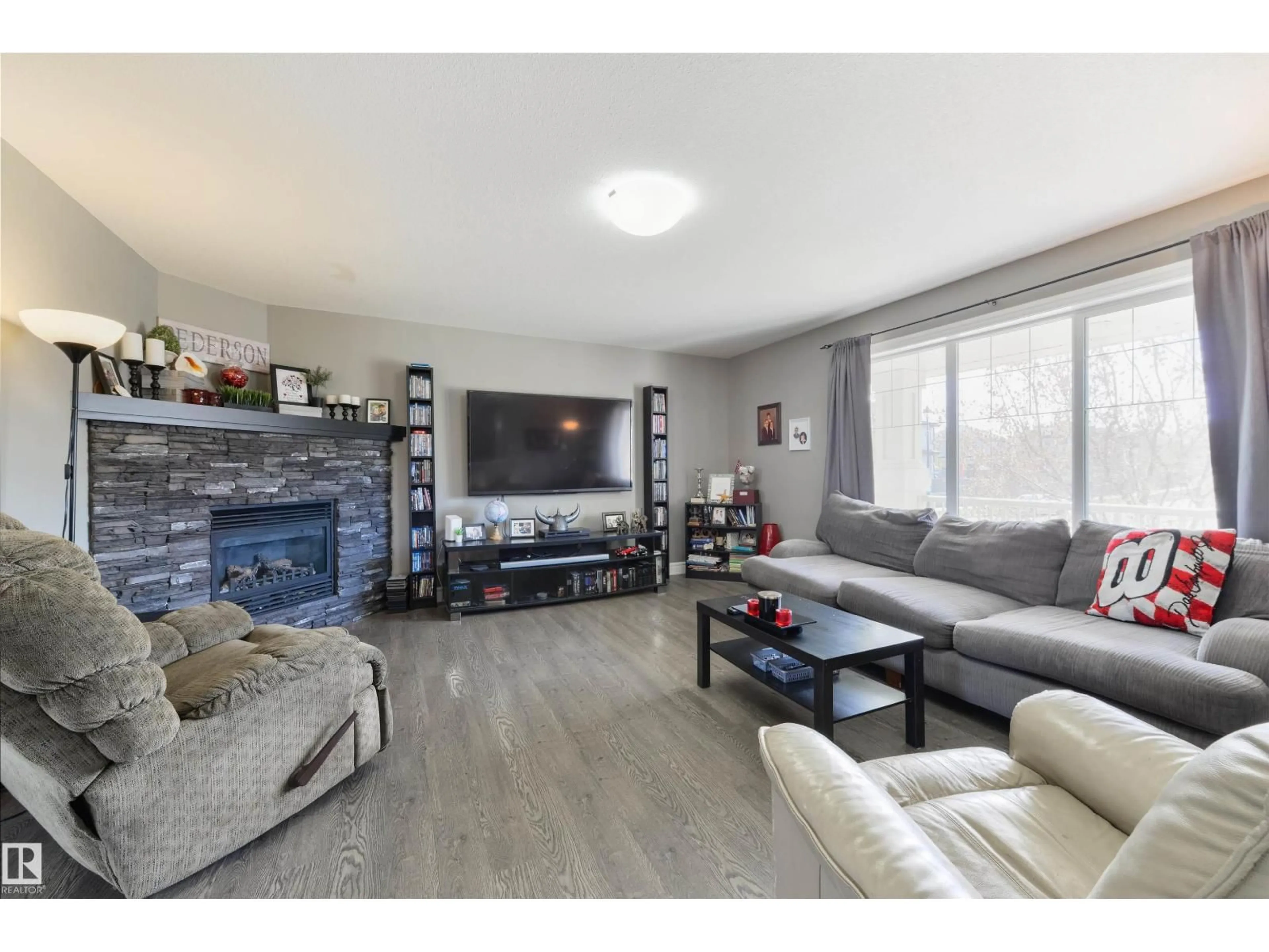 Living room with furniture, wood/laminate floor for 102 KIRPATRICK BN, Leduc Alberta T9E0W3