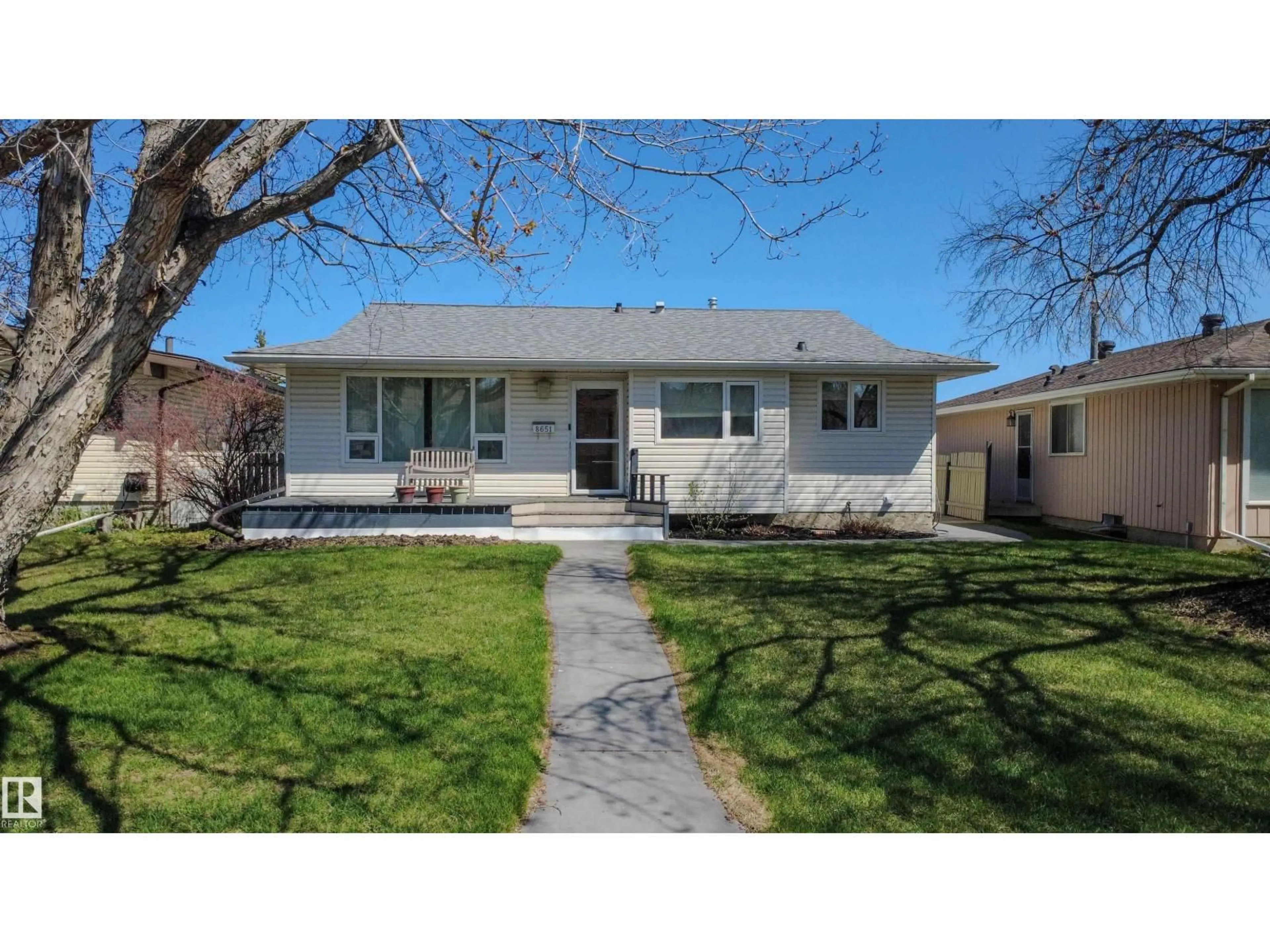 Home with vinyl exterior material, street for 8651 27 AV, Edmonton Alberta T6T1X7