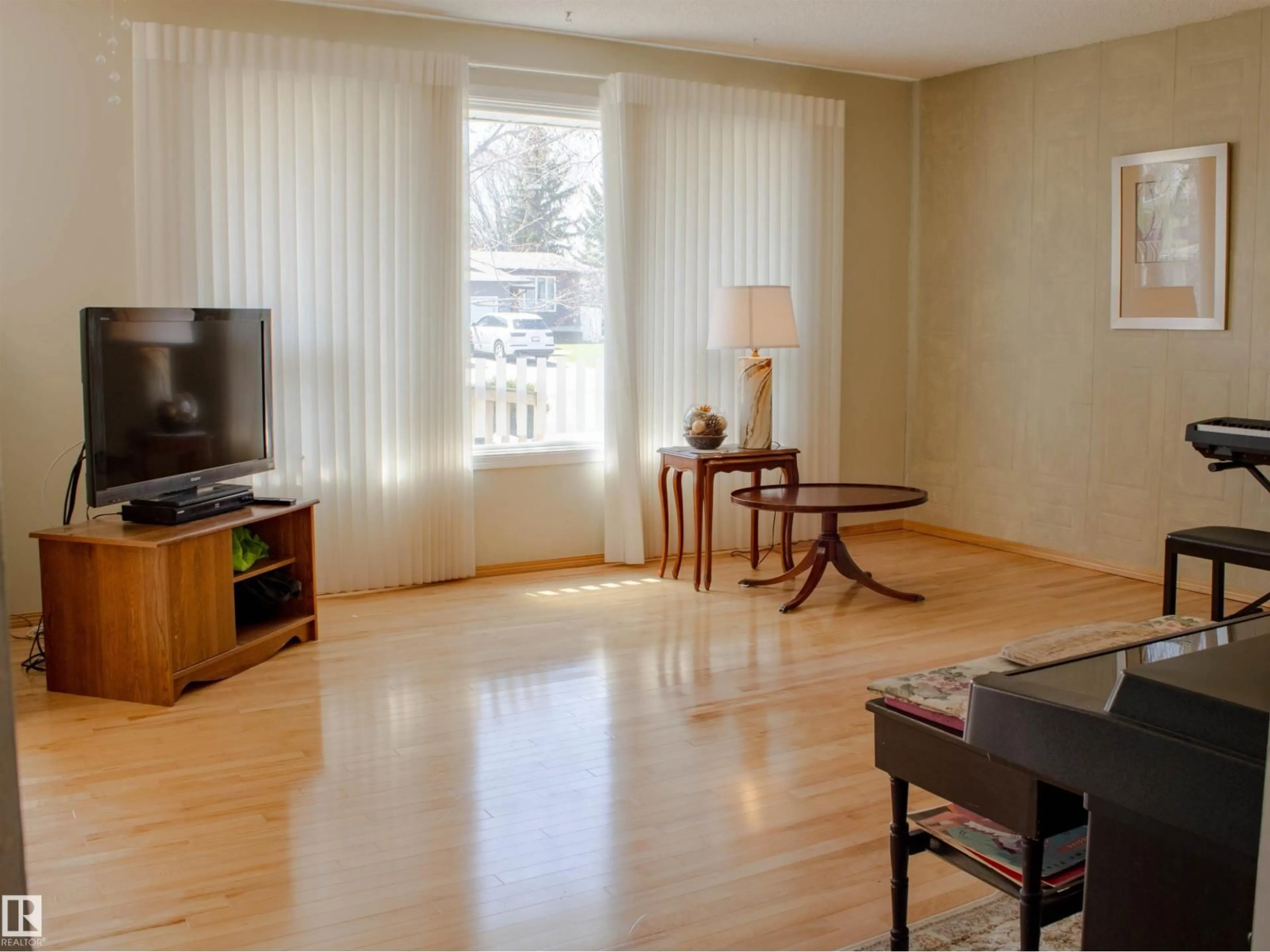 Living room with furniture, wood/laminate floor for 8651 27 AV, Edmonton Alberta T6T1X7