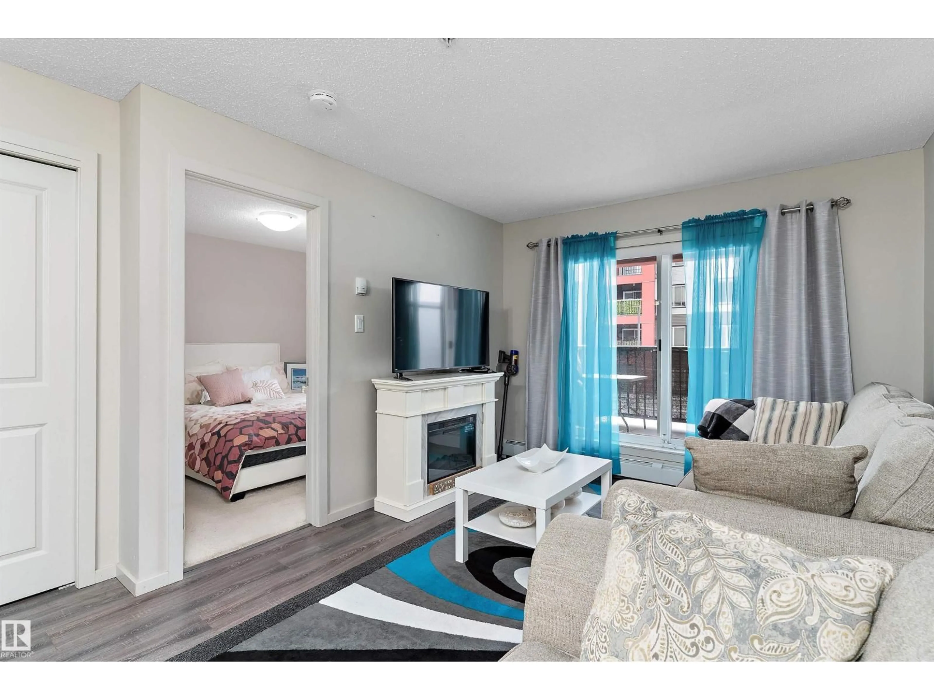 Living room with furniture, wood/laminate floor for #221 - 344 WINDERMERE RD, Edmonton Alberta T6W2P2
