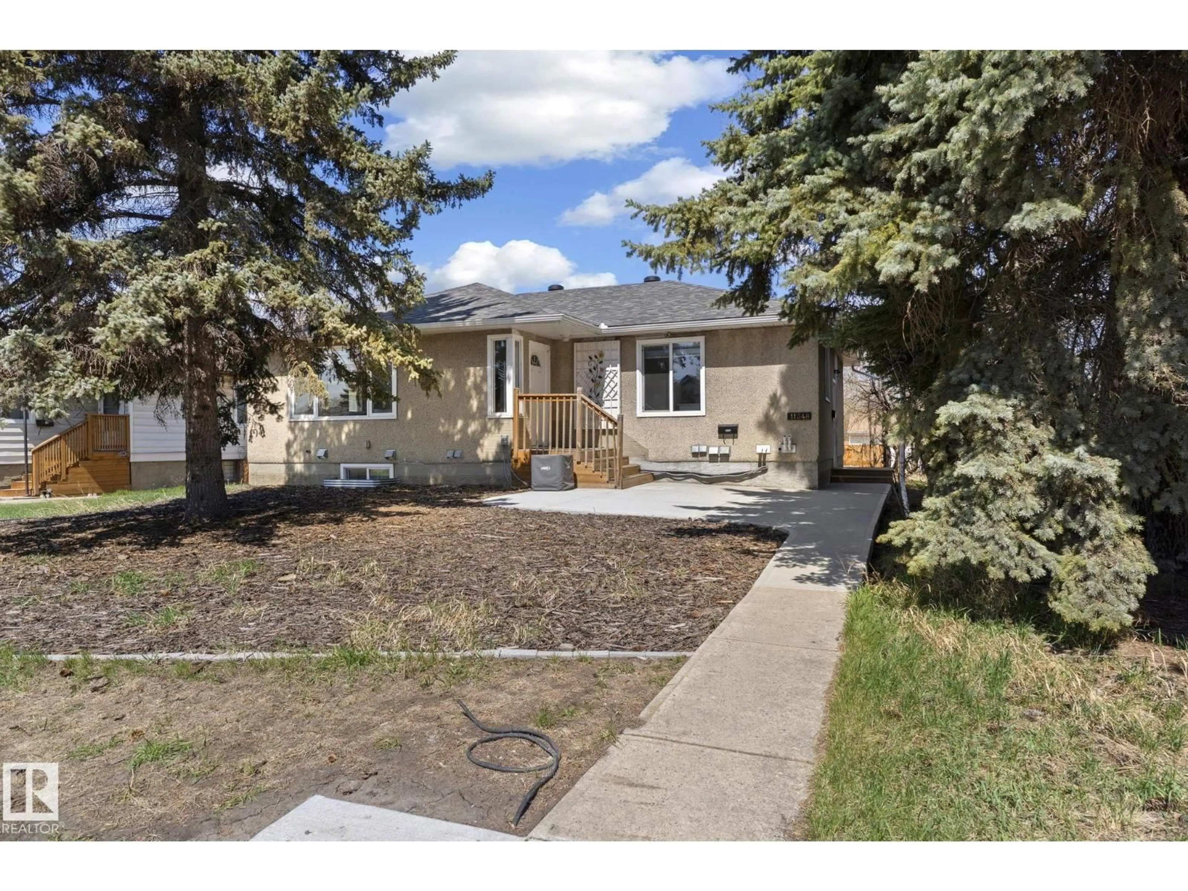 Home with vinyl exterior material, street for 11348 111 AV, Edmonton Alberta T5G0C9