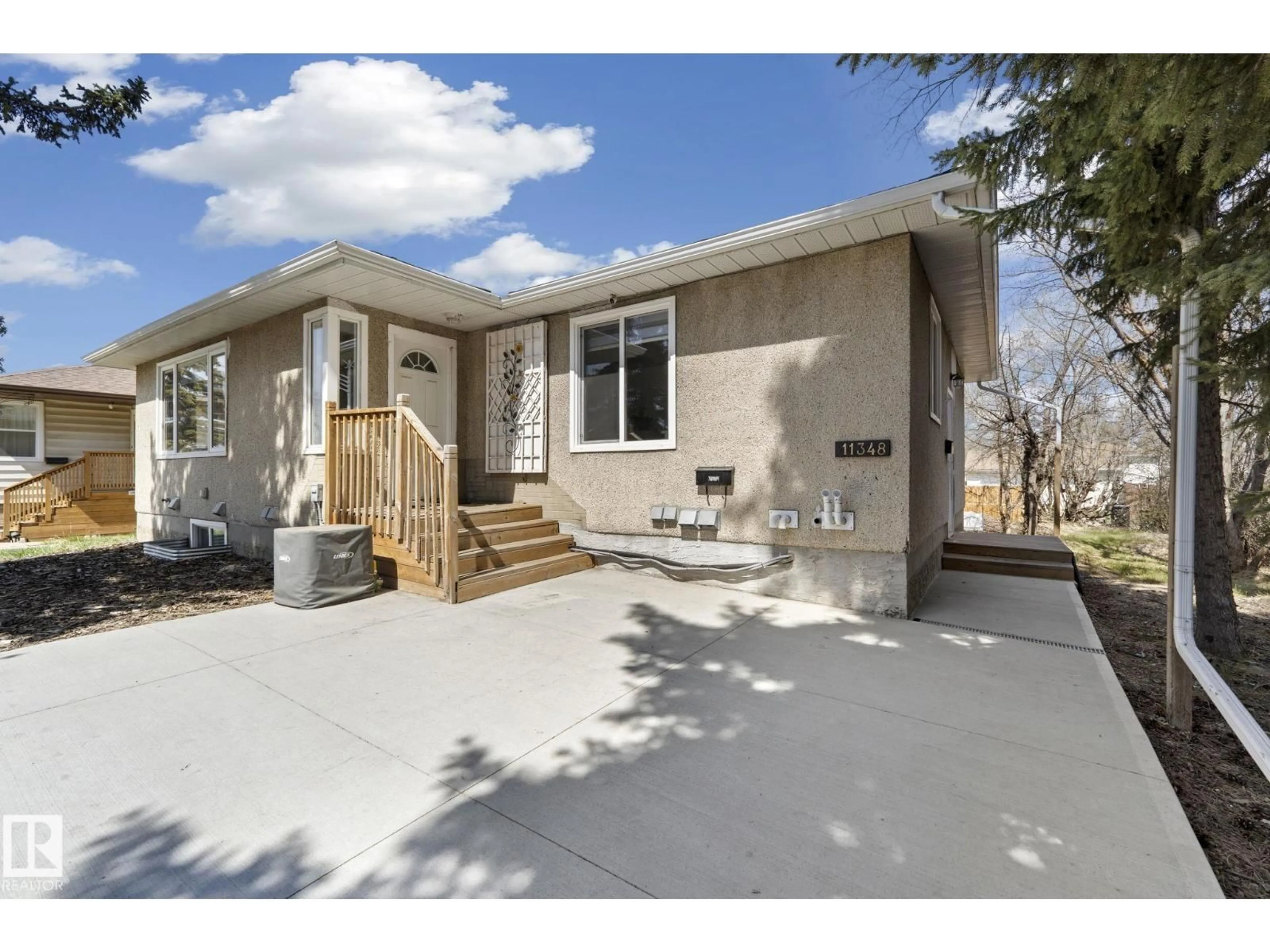 Home with vinyl exterior material, street for 11348 111 AV, Edmonton Alberta T5G0C9