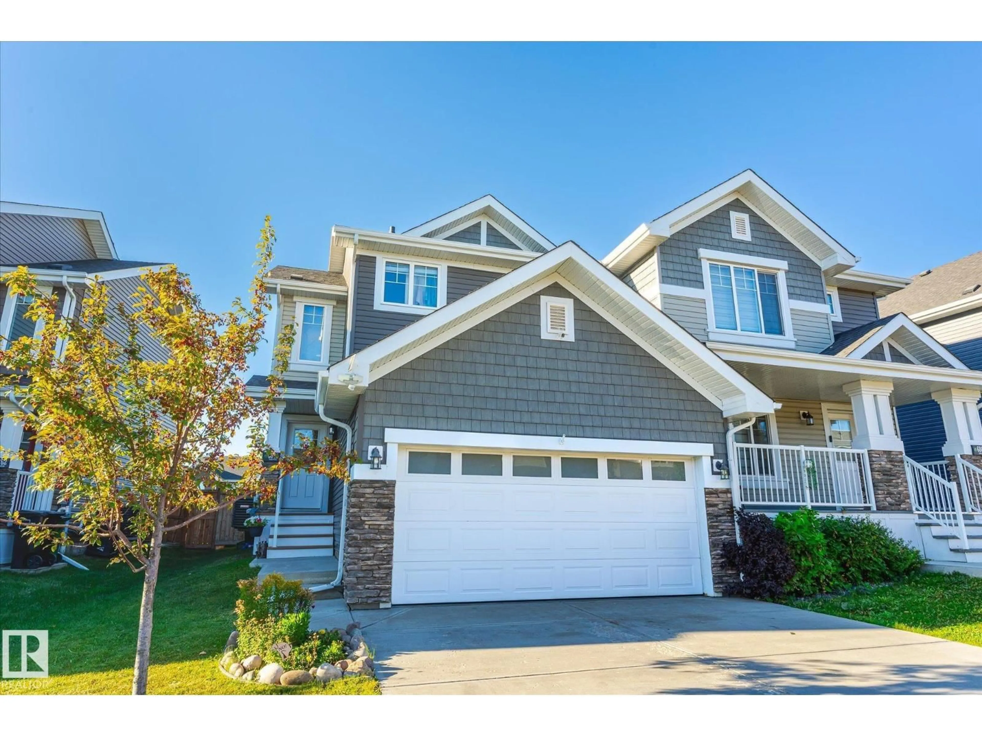 Home with vinyl exterior material, street for 6864 EVANS WD, Edmonton Alberta T6M0T6