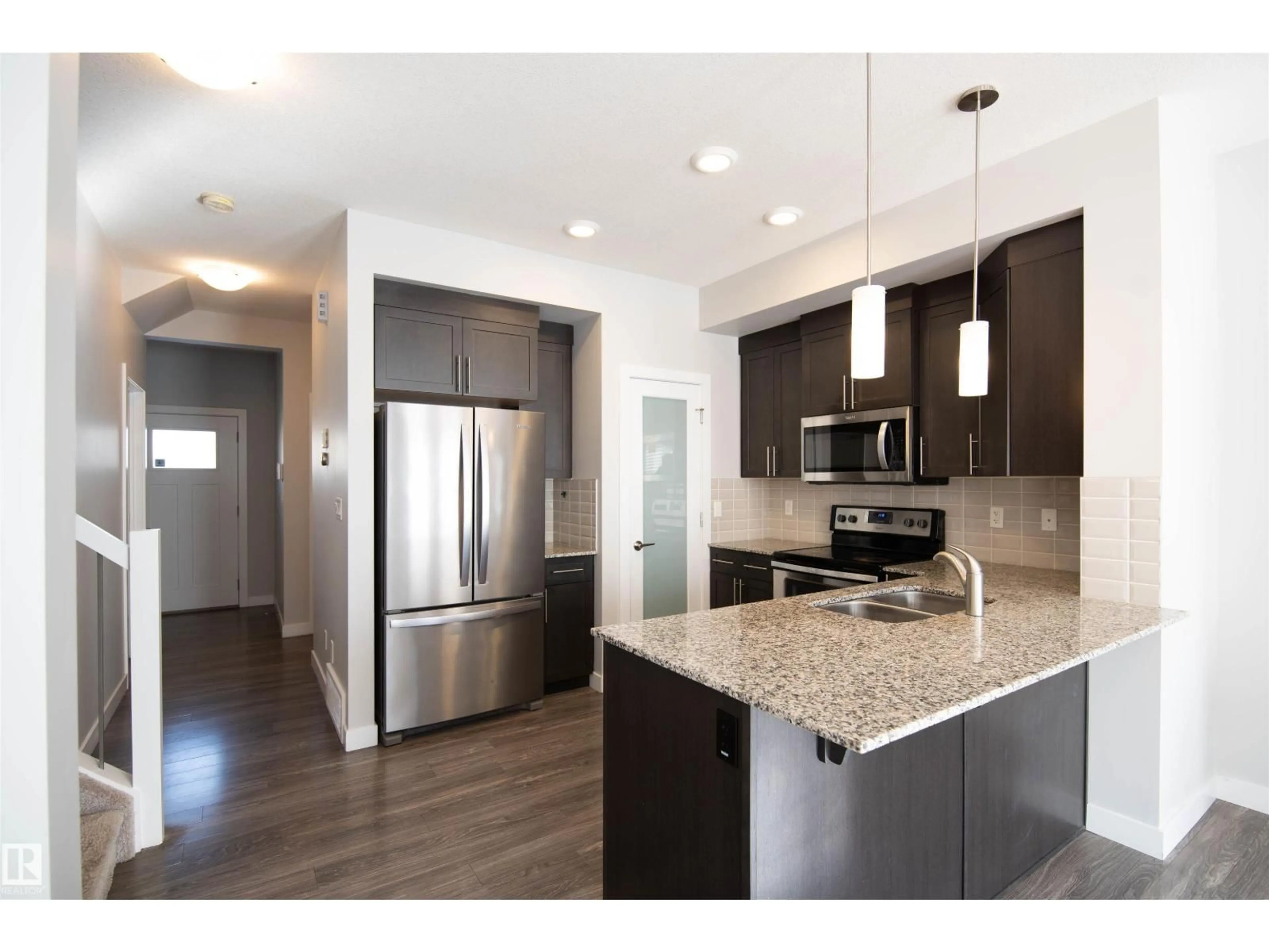 Open concept kitchen, wood/laminate floor for SW - 1793 KEENE CR, Edmonton Alberta T6W3W3