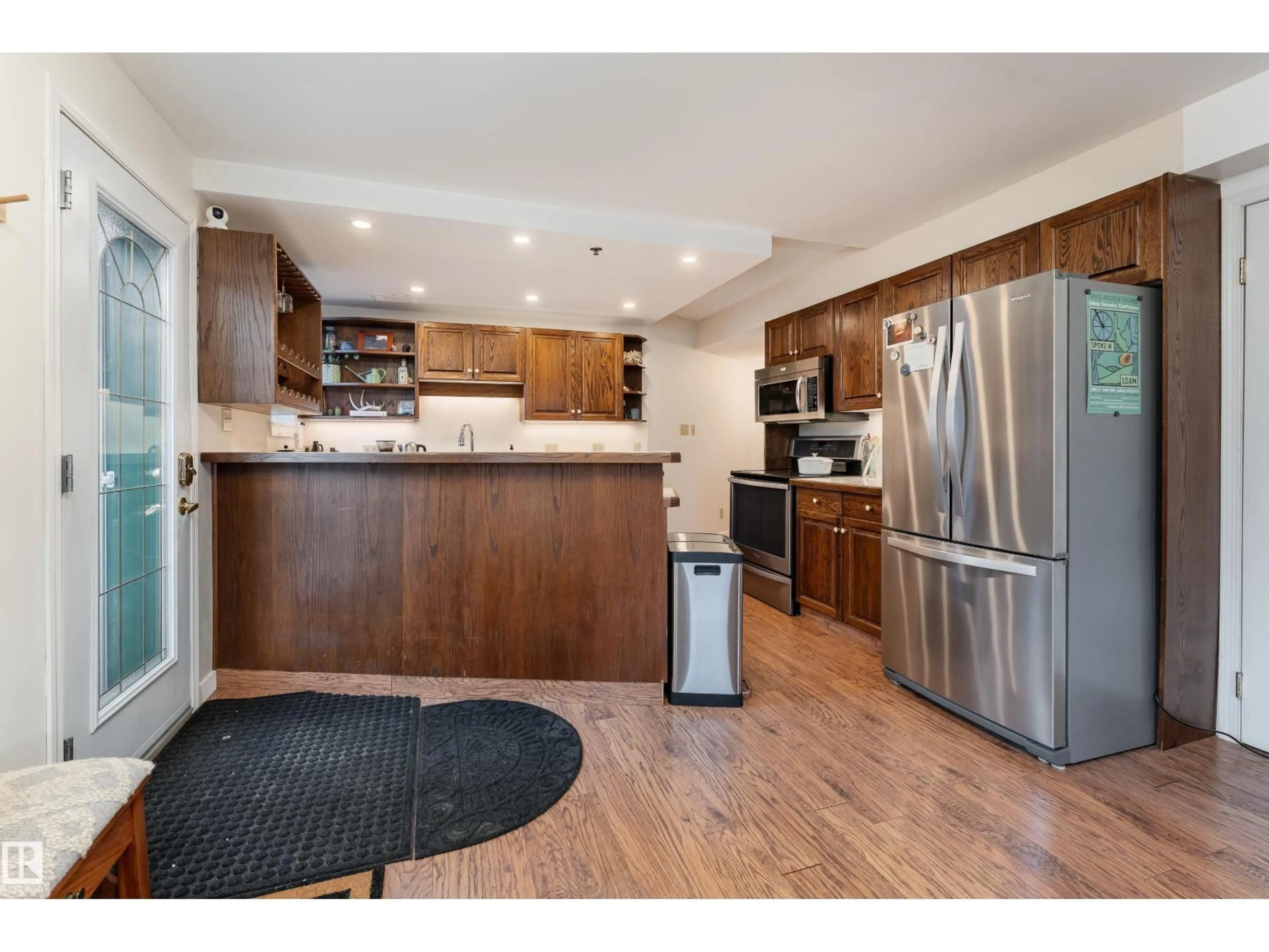 Open concept kitchen, wood/laminate floor for #101 - 9131 99 ST, Edmonton Alberta T6E3V9