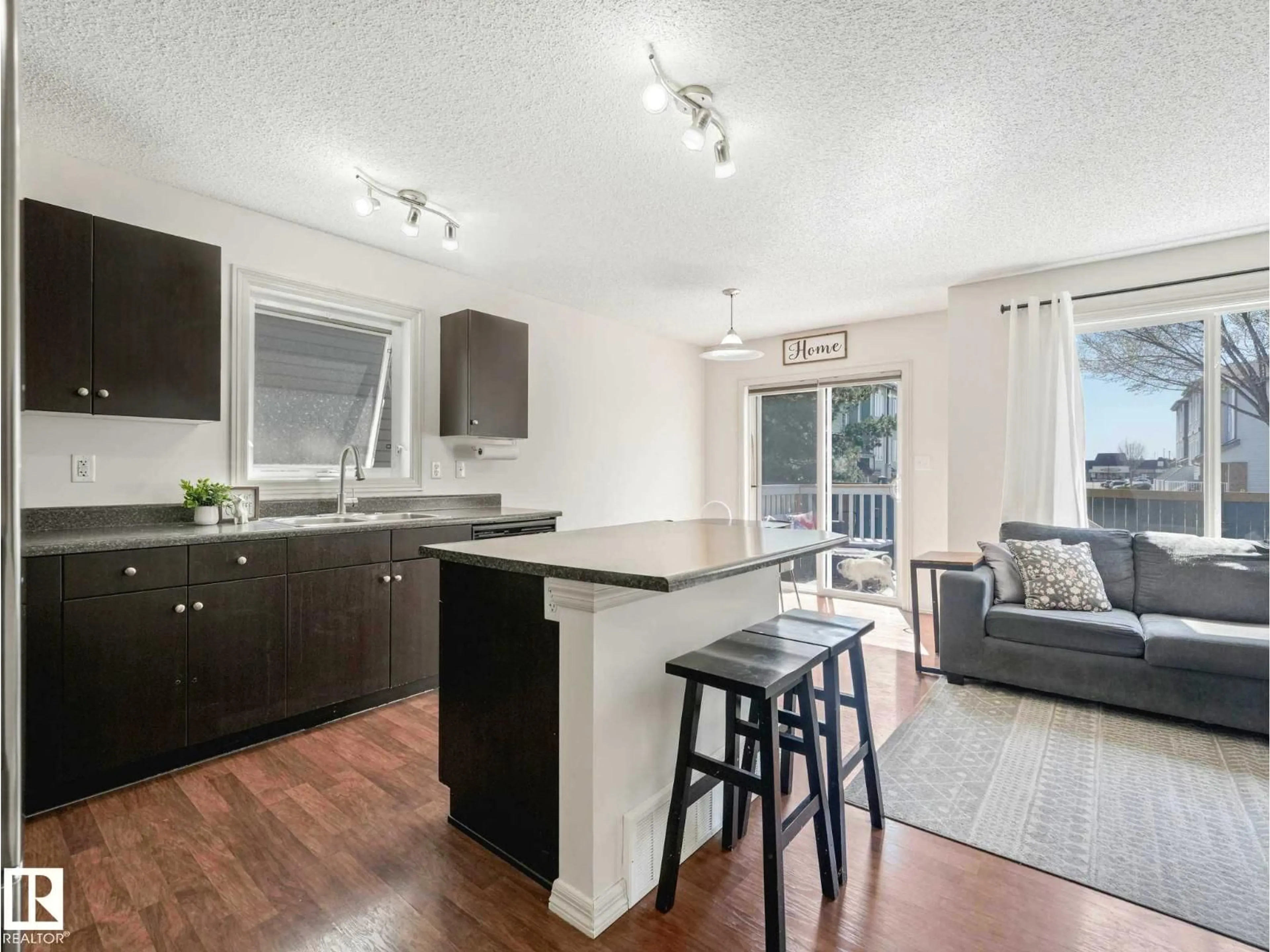Open concept kitchen, wood/laminate floor for 26 5101 SOLEIL BV, Beaumont Alberta T4X0E3