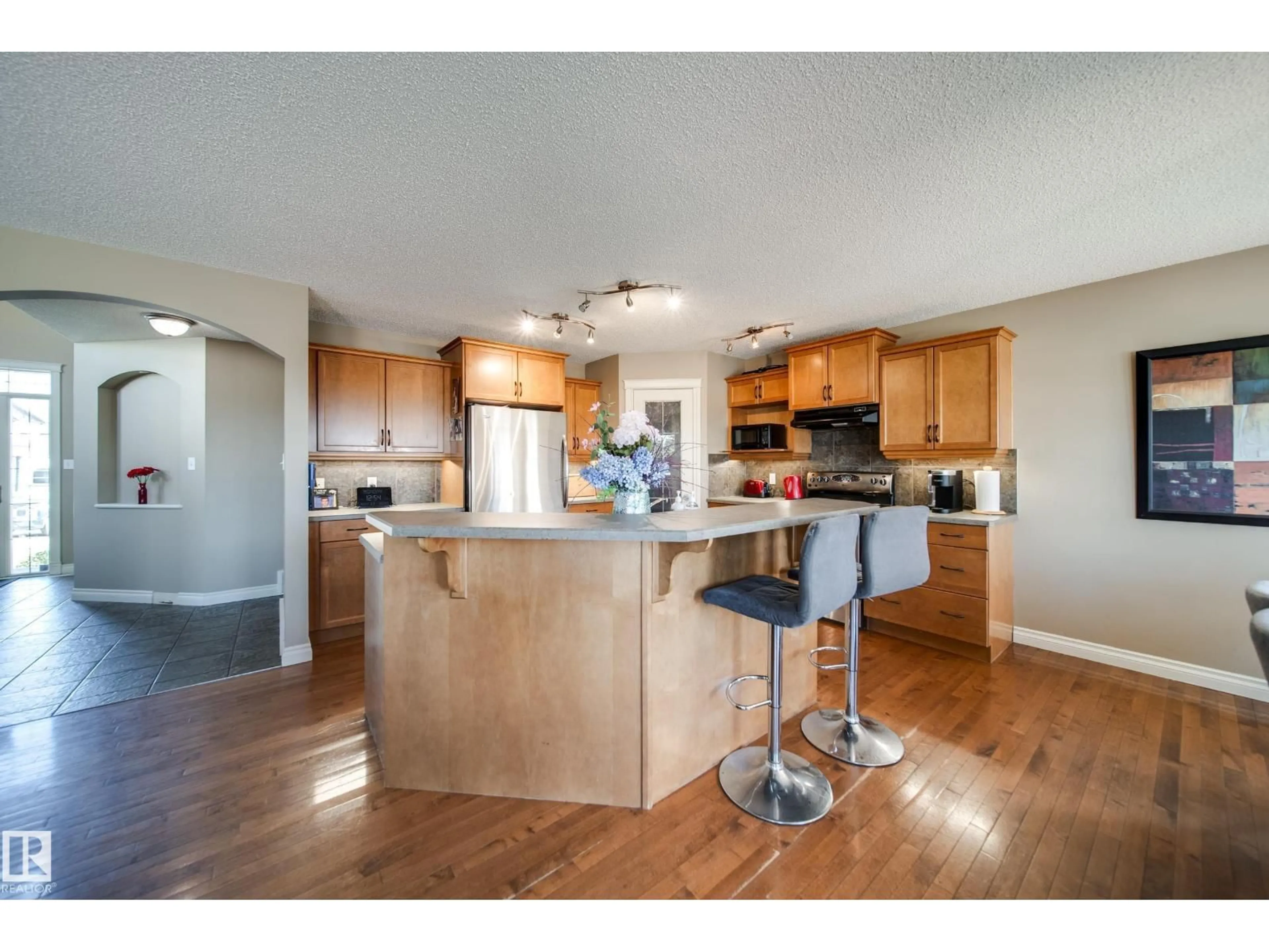 Open concept kitchen, wood/laminate floor for 12627 16 AV, Edmonton Alberta T6W1R6