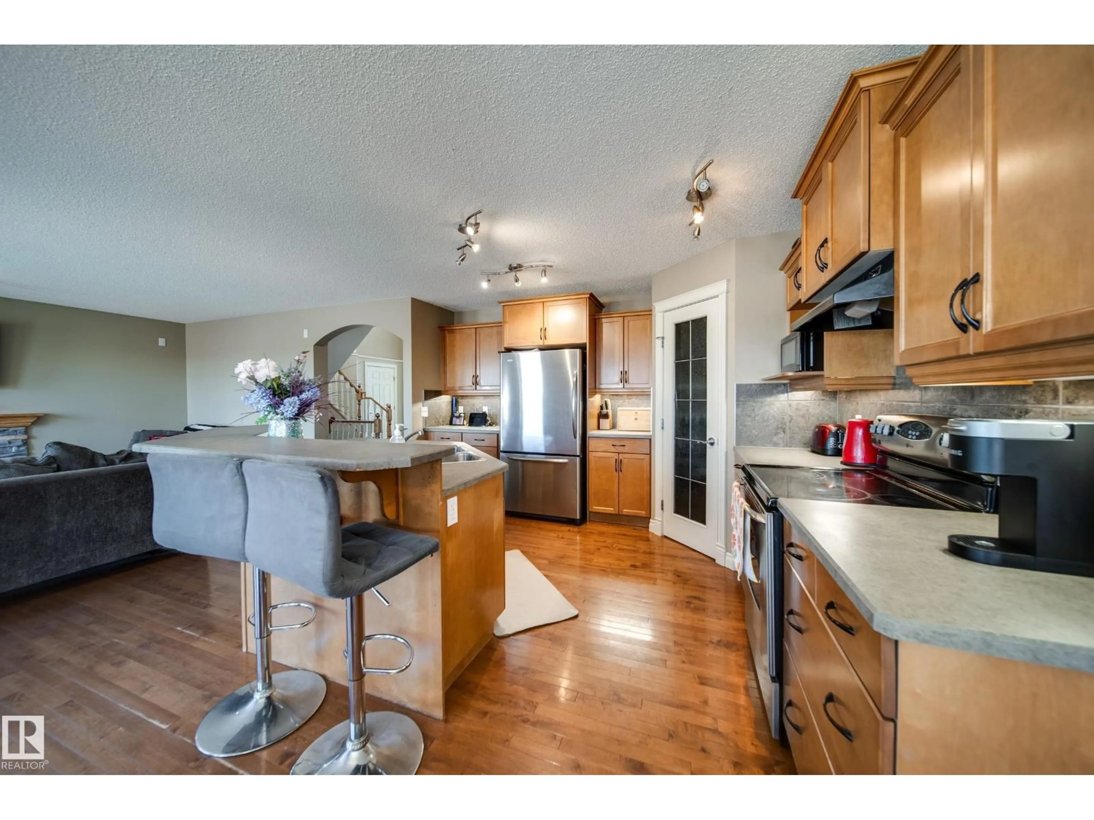 Open concept kitchen, wood/laminate floor for 12627 16 AV, Edmonton Alberta T6W1R6
