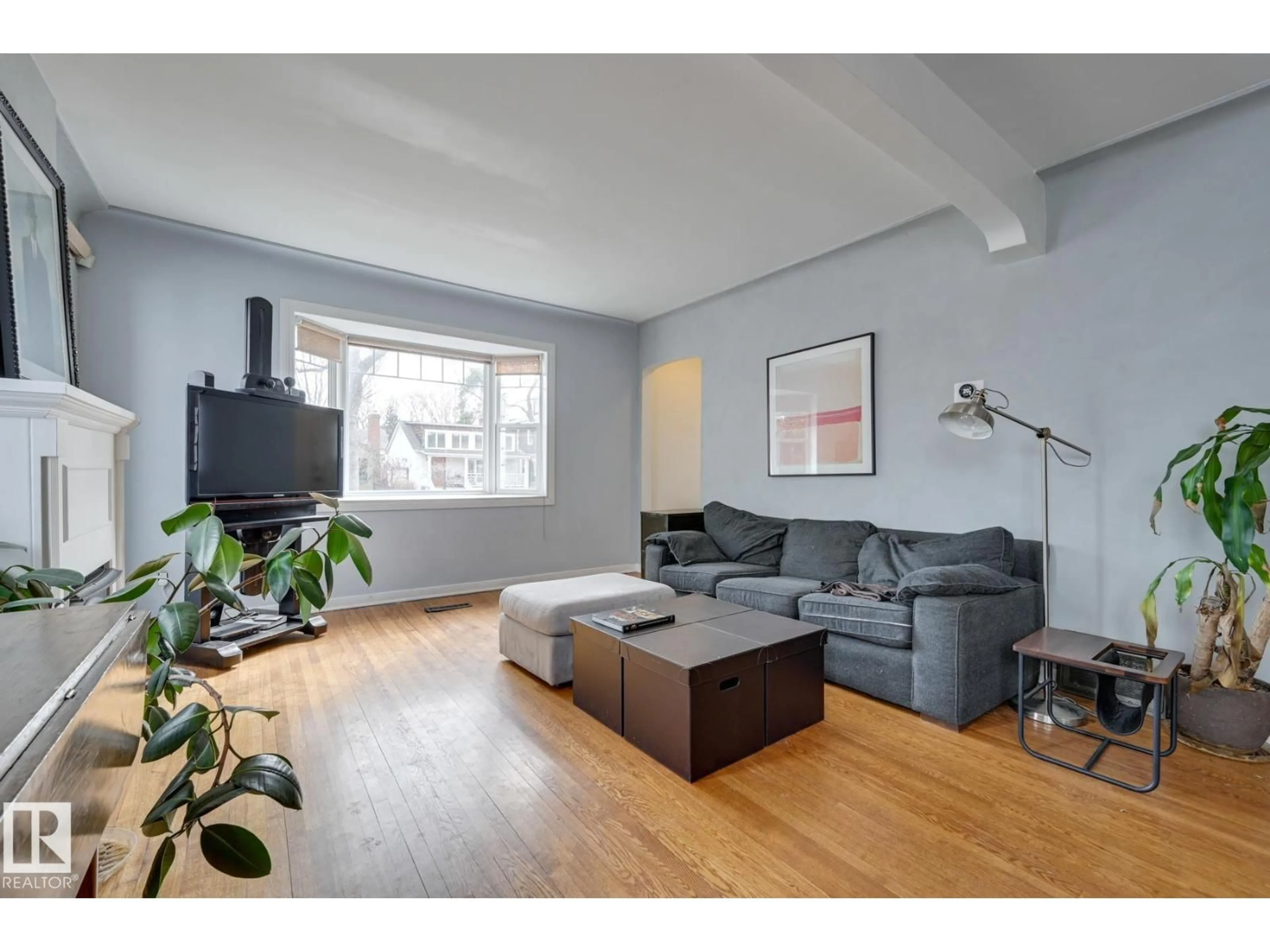 Living room with furniture, wood/laminate floor for 10038 88 AV, Edmonton Alberta T6E2R7