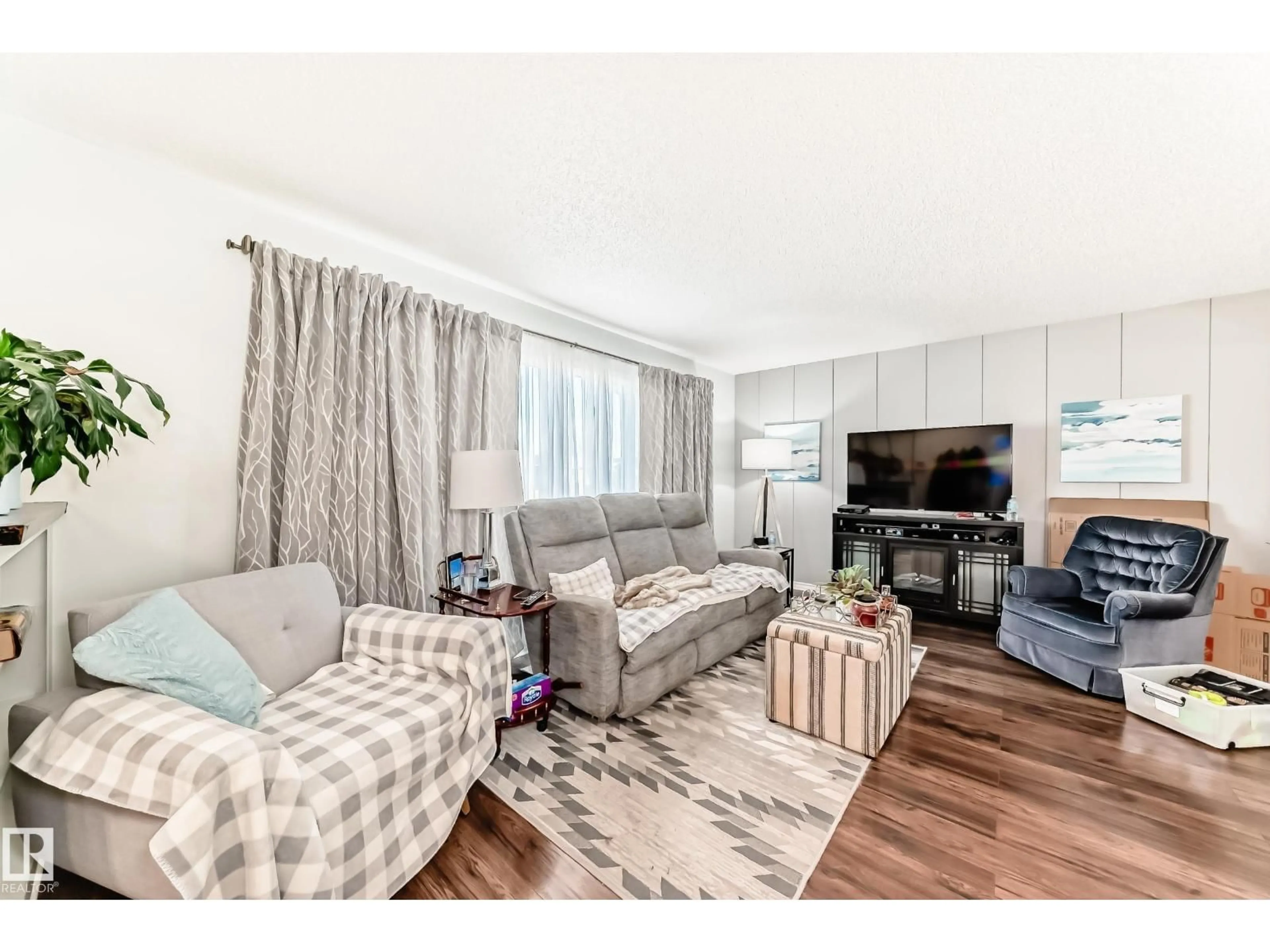 Living room with furniture, wood/laminate floor for 3611 108 ST, Edmonton Alberta T6J1B3