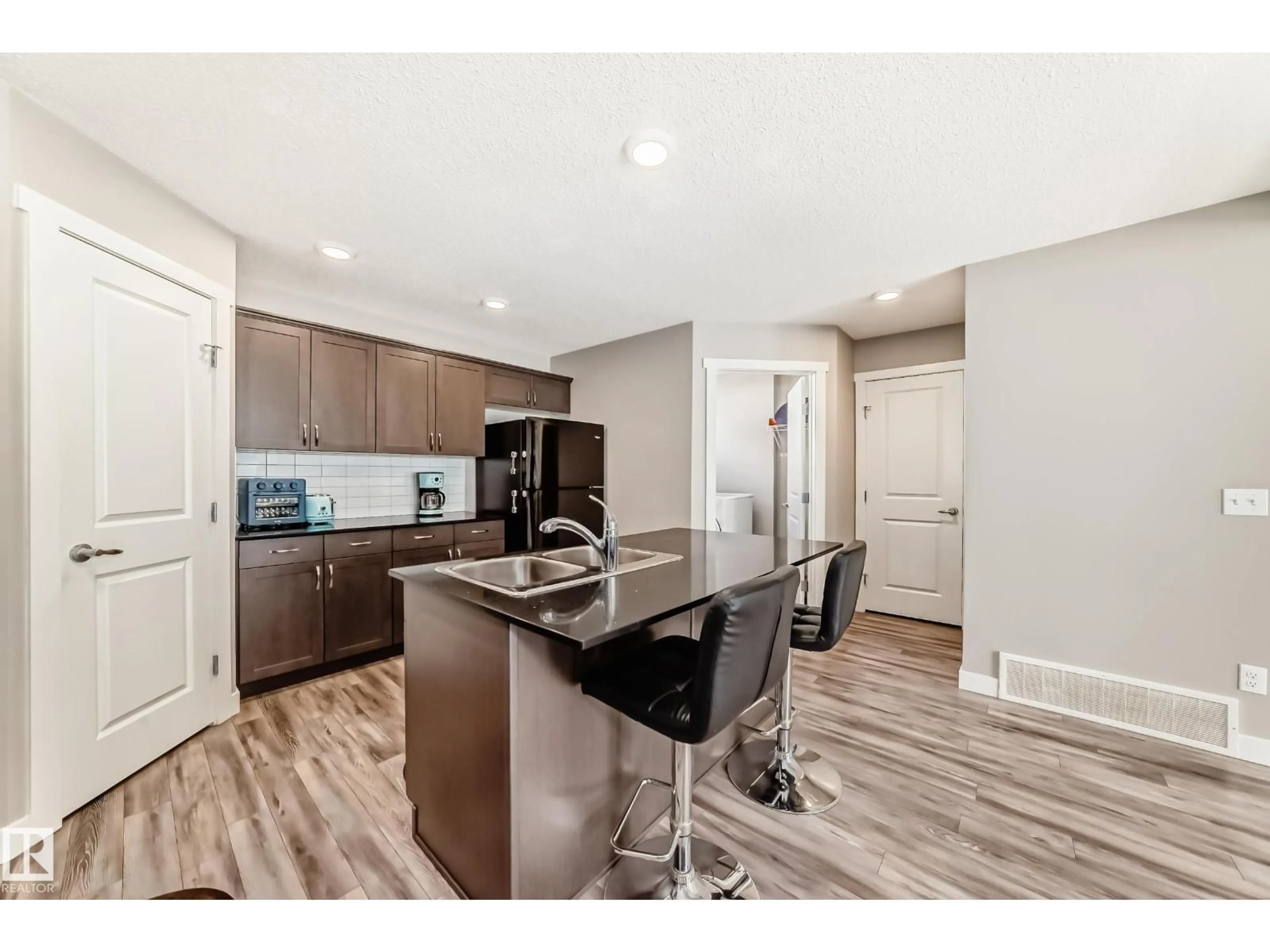 Open concept kitchen, wood/laminate floor for #108 - 17832 78 ST, Edmonton Alberta T5Z0L7