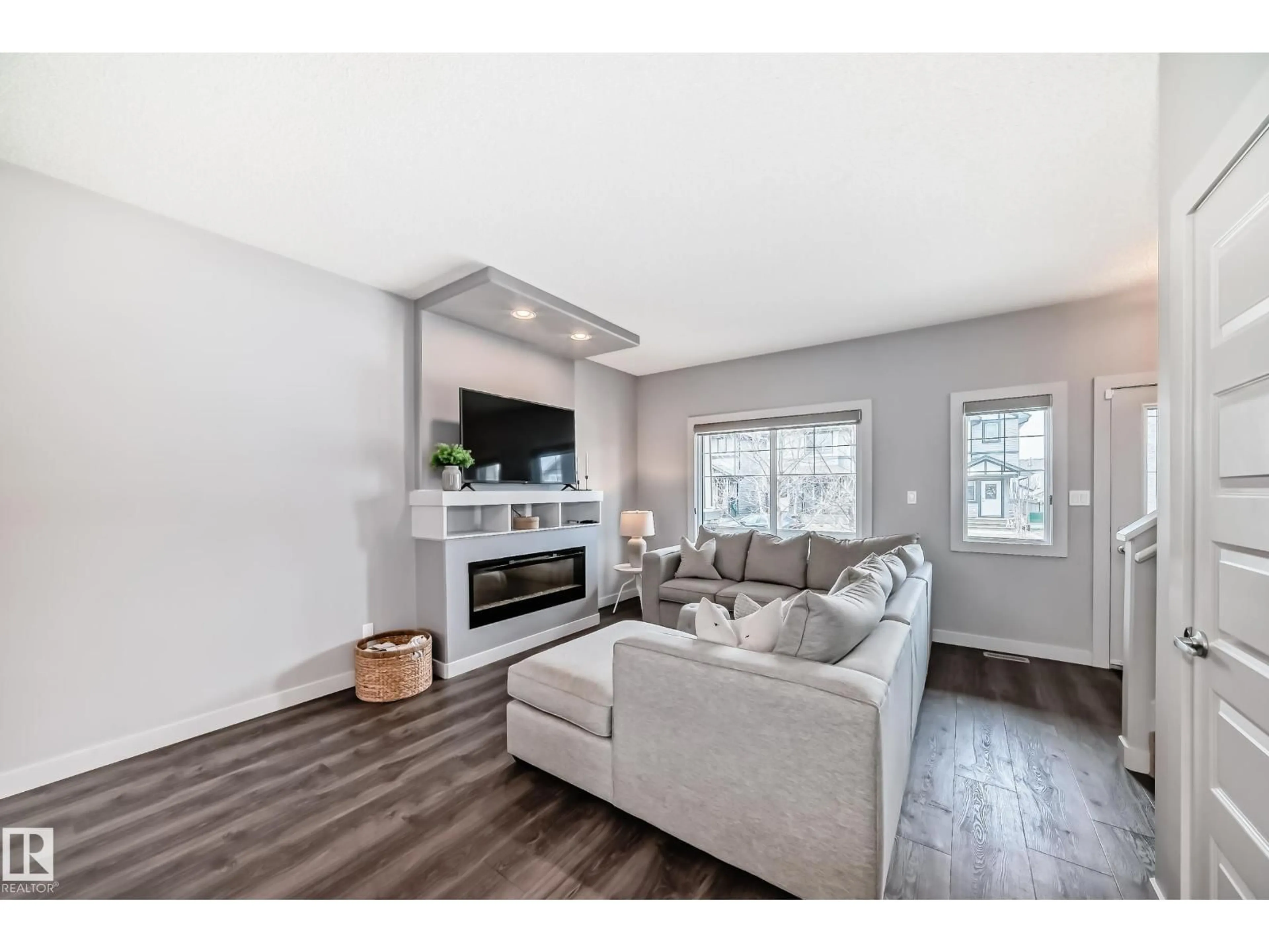 Living room with furniture, wood/laminate floor for SW - 6919 CARDINAL WD, Edmonton Alberta T6W2Y3