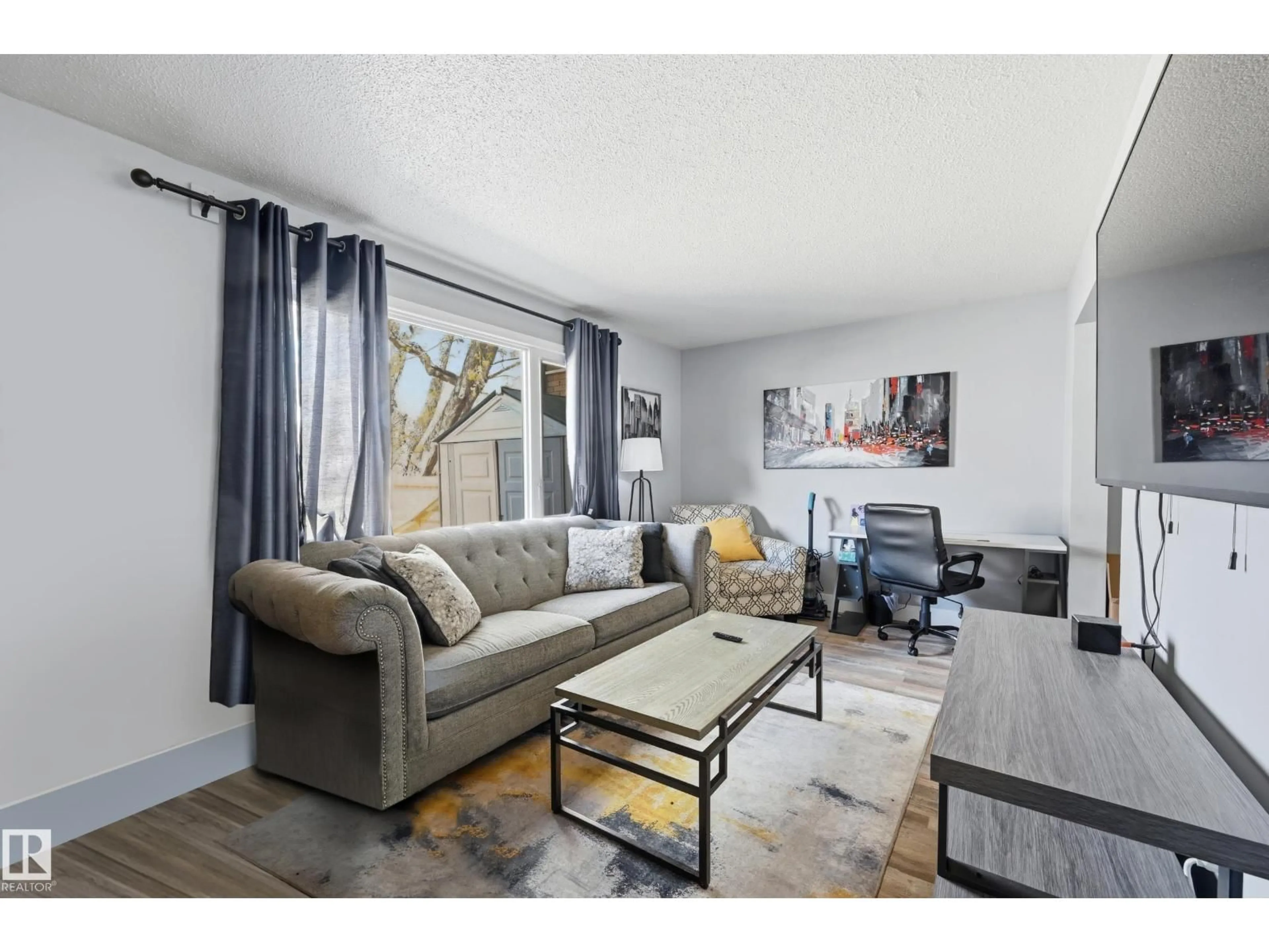 Living room with furniture, wood/laminate floor for #9 - 8020 141 AV NW, Edmonton Alberta T5C2N9