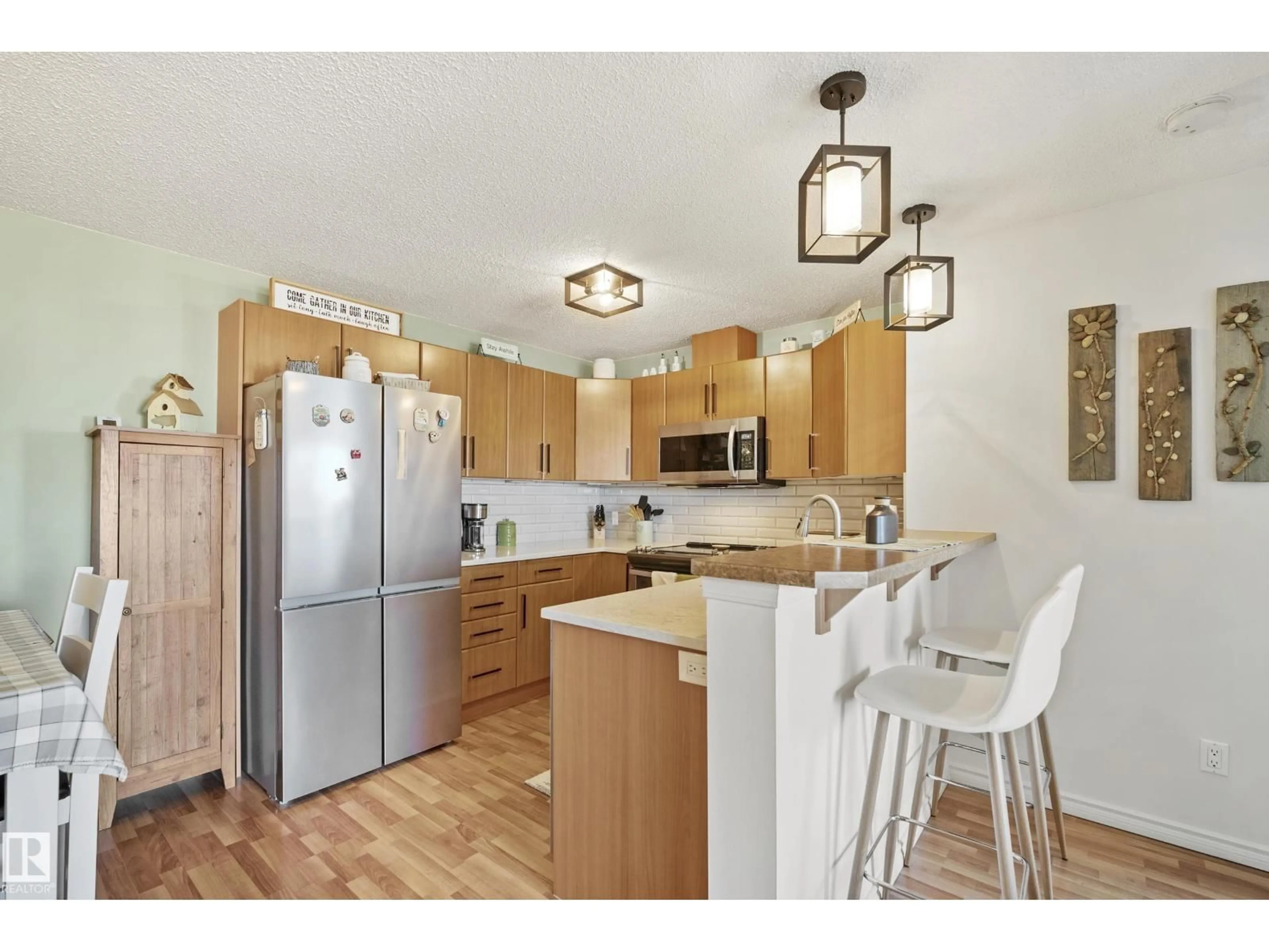 Open concept kitchen, wood/laminate floor for #440 - 2436 GUARDIAN RD, Edmonton Alberta T5T2P5
