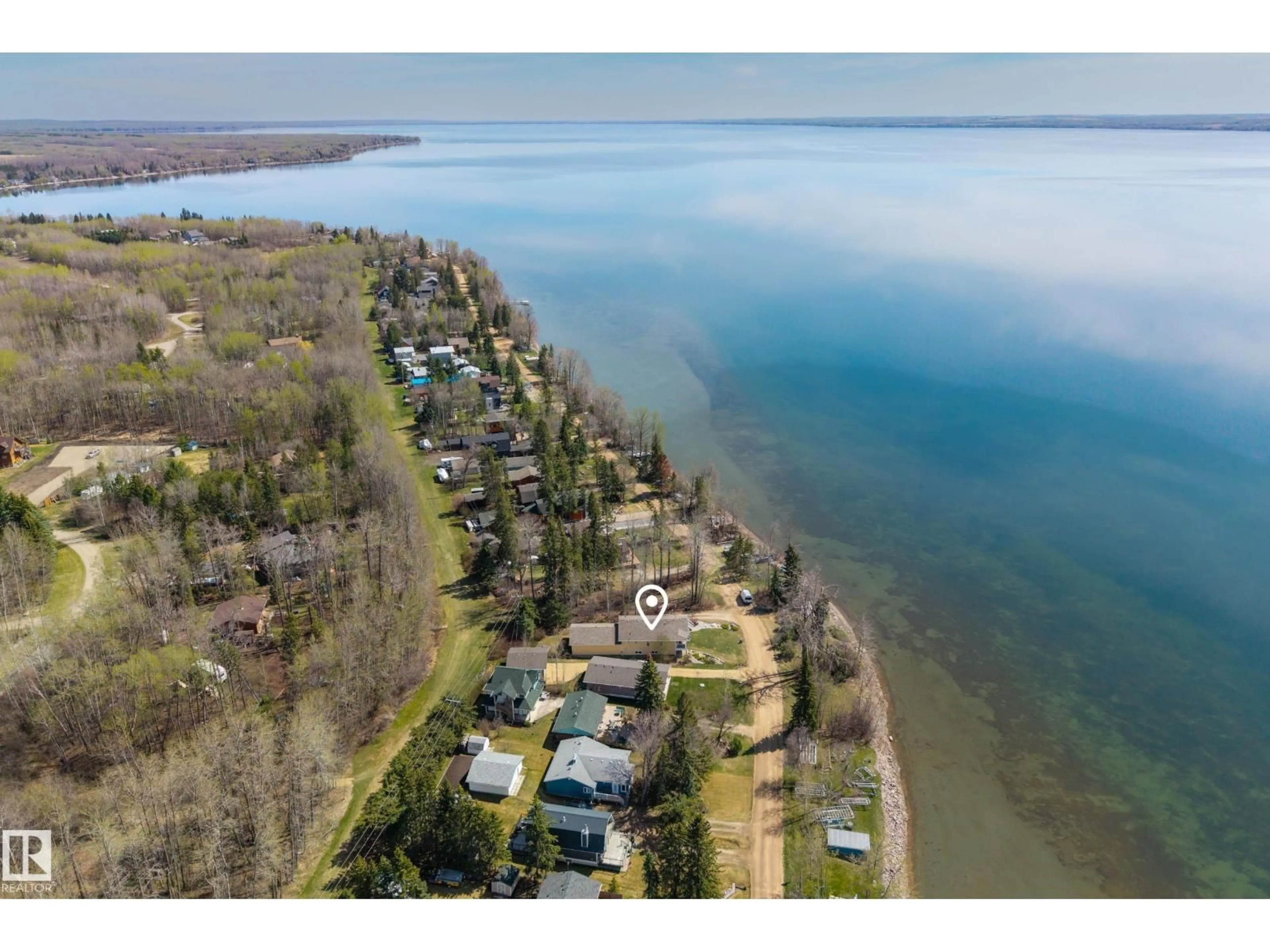 A pic from outside/outdoor area/front of a property/back of a property/a pic from drone, water/lake/river/ocean view for 77 LAKESHORE DR, Rural Leduc County Alberta T0C2P0