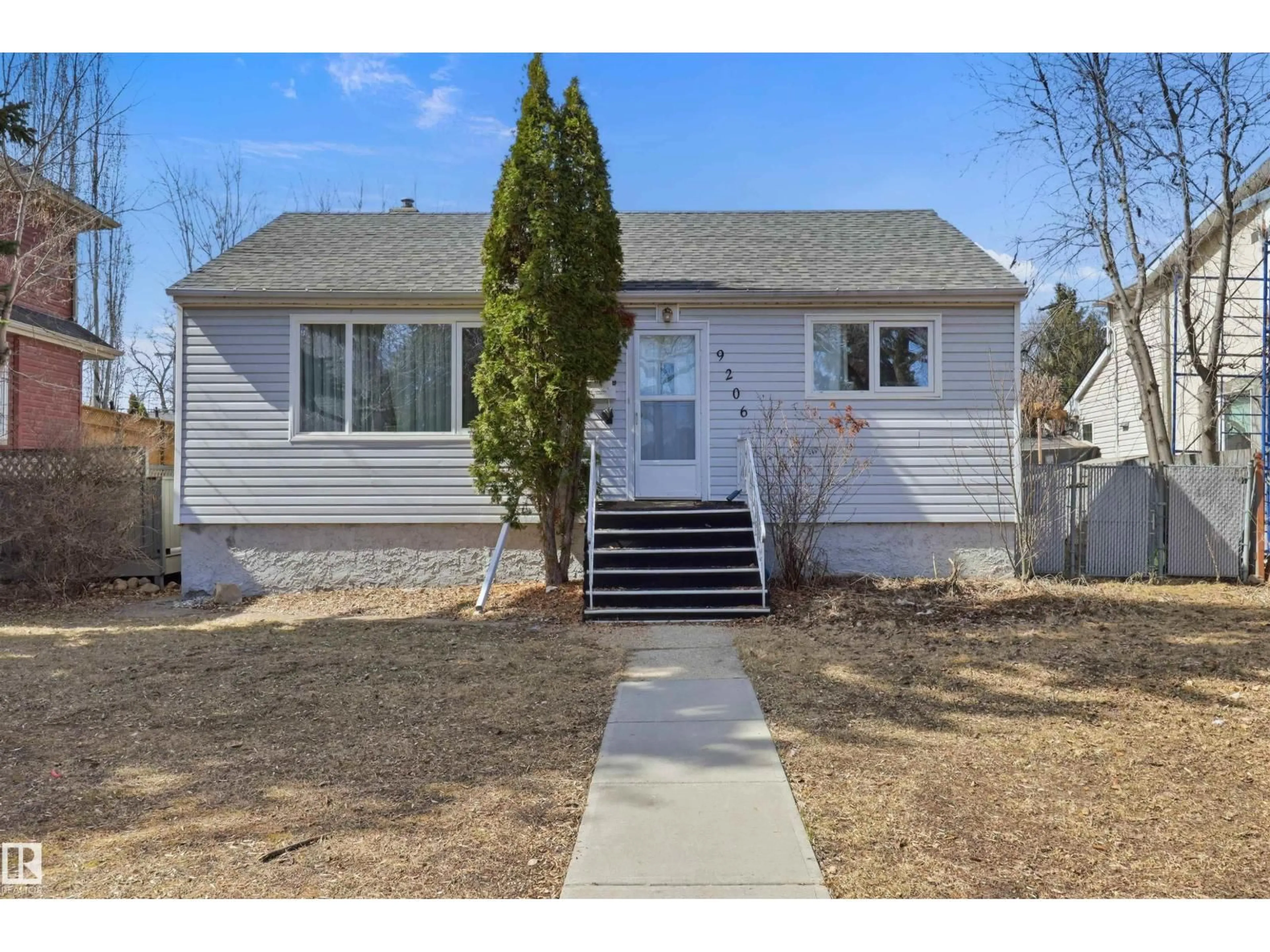 Home with vinyl exterior material, street for 9208 - 9206 90 ST, Edmonton Alberta T6C3M1
