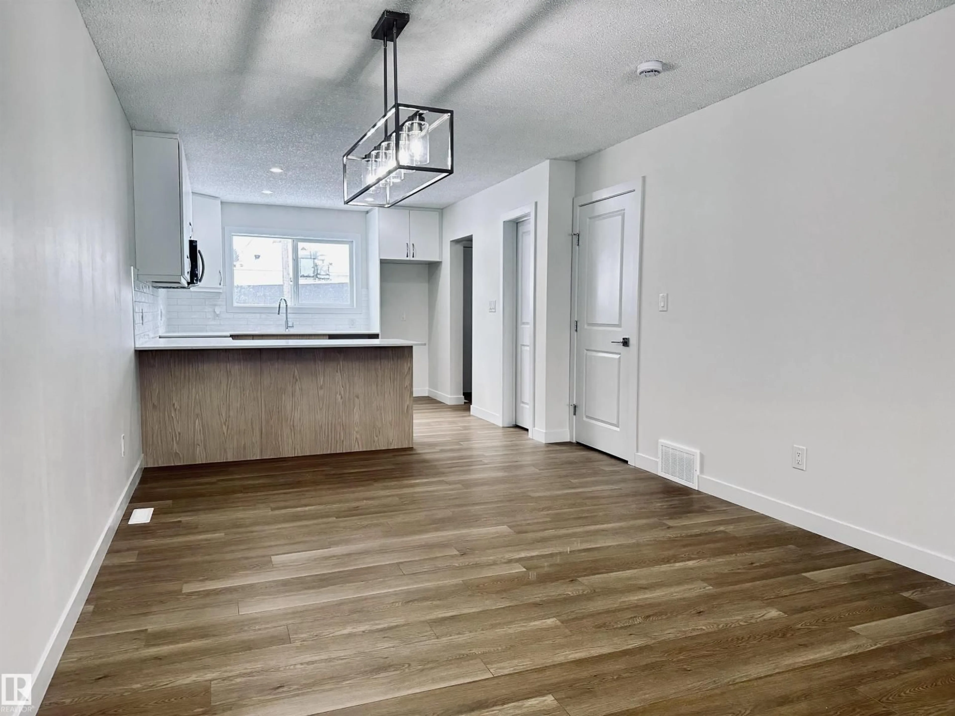Open concept kitchen, wood/laminate floor for 4843 115 AV, Edmonton Alberta T5W0W3