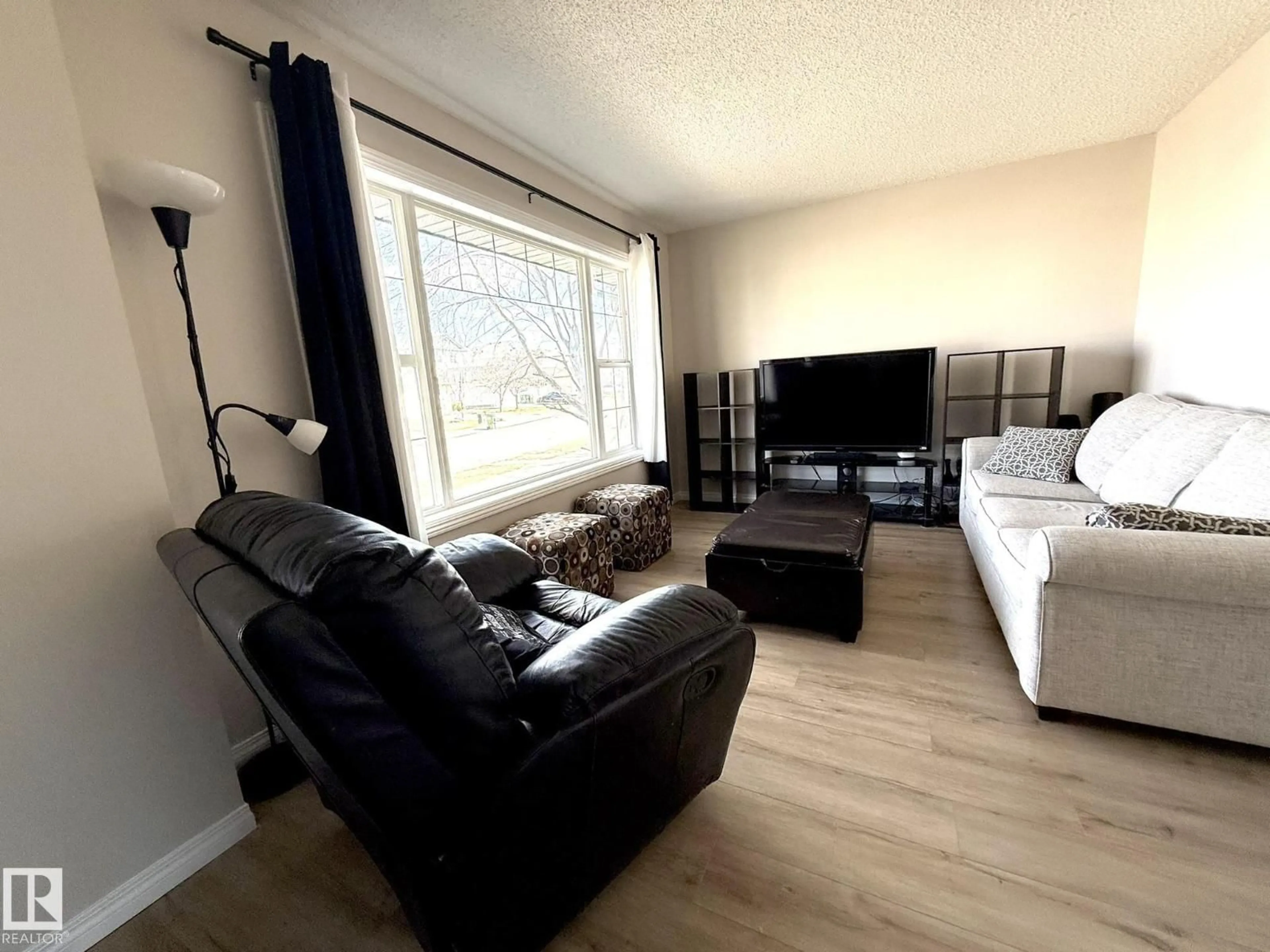 Living room with furniture, wood/laminate floor for 645 WINDROSS CR, Edmonton Alberta T6T1Y1
