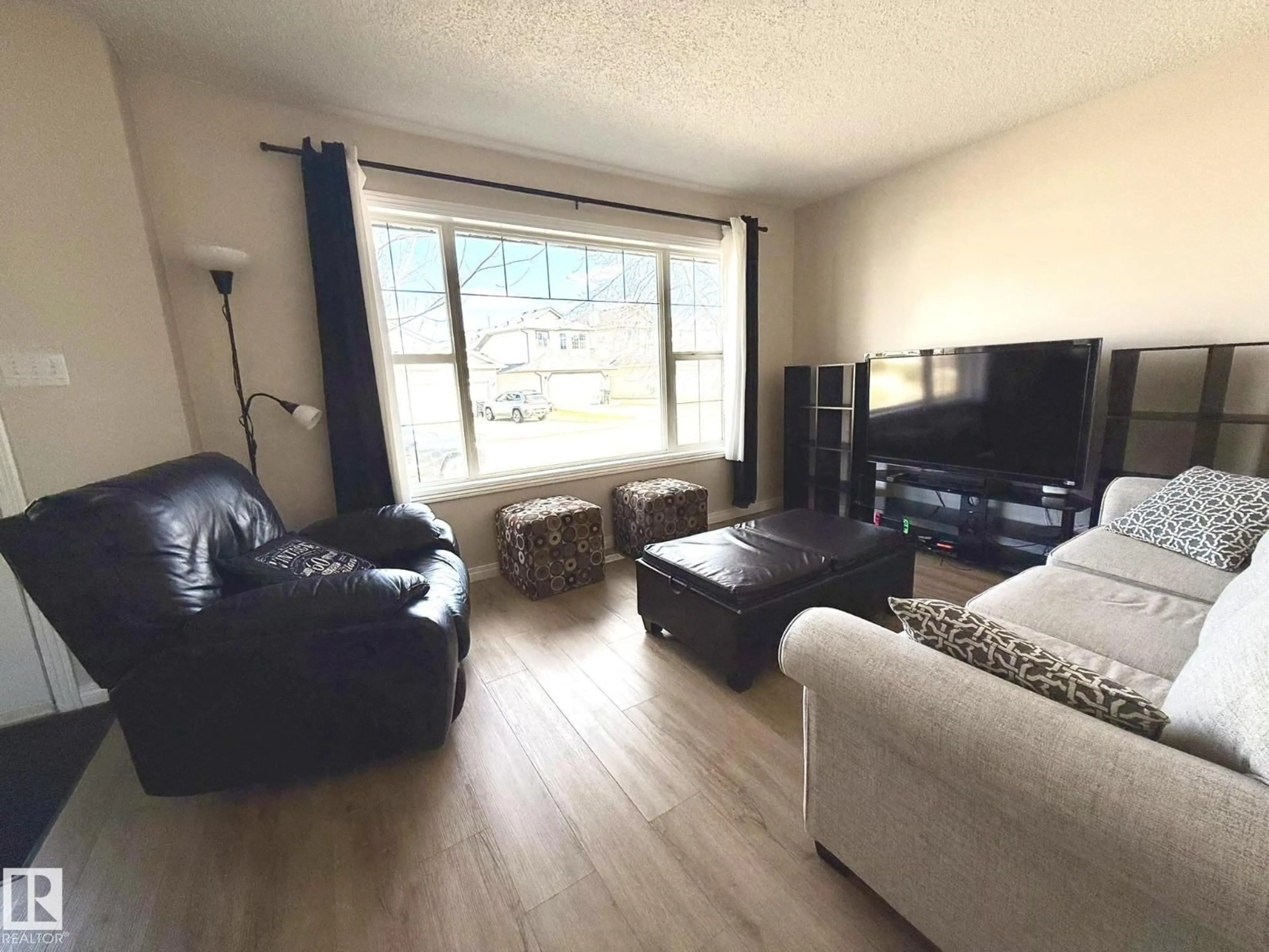 Living room with furniture, wood/laminate floor for 645 WINDROSS CR, Edmonton Alberta T6T1Y1