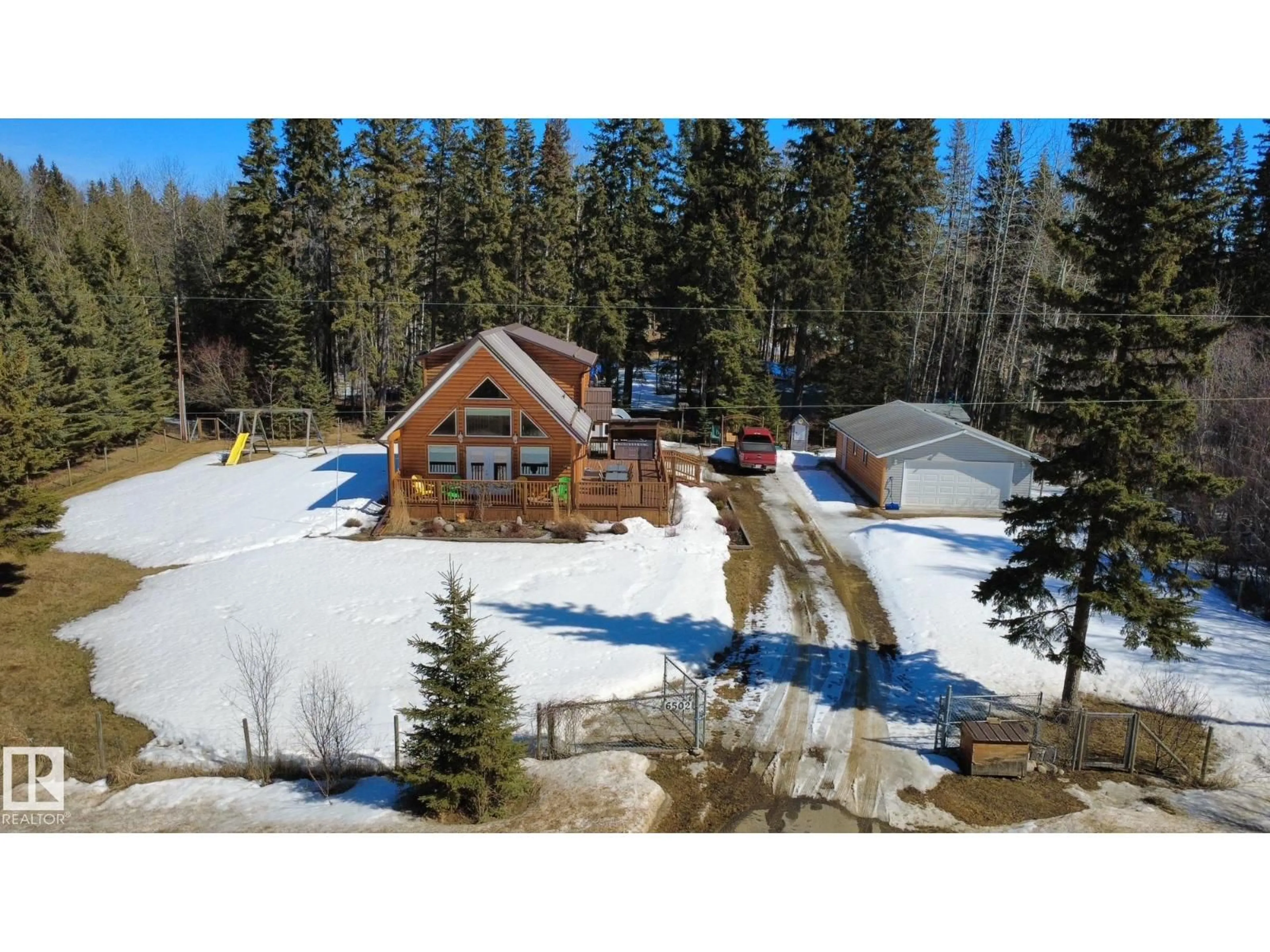 A pic from outside/outdoor area/front of a property/back of a property/a pic from drone, unknown for 6502 50 ST, Rural Wetaskiwin County Alberta T0C2C0