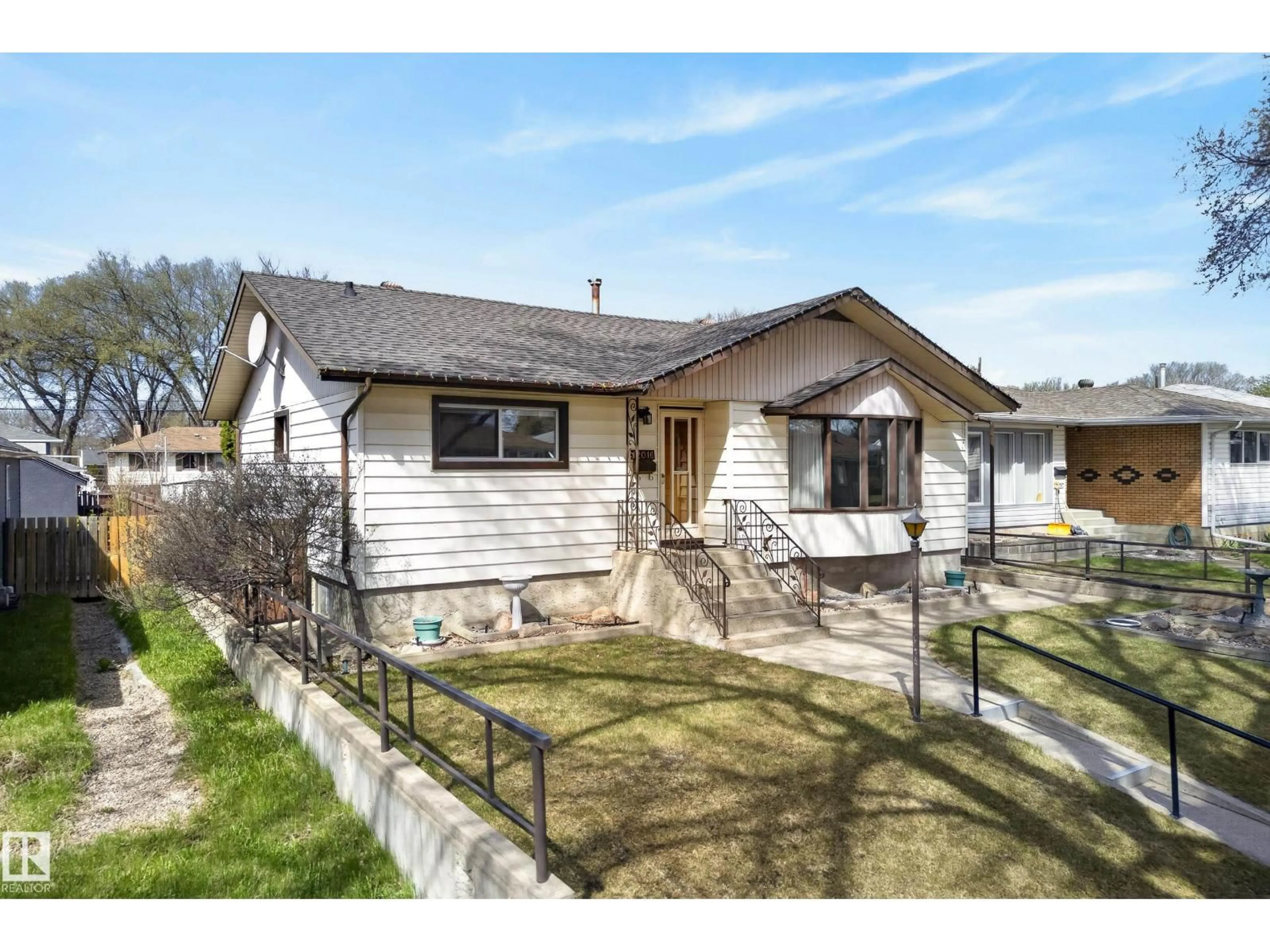 Home with vinyl exterior material, street for 12016 51 ST, Edmonton Alberta T5W3G7
