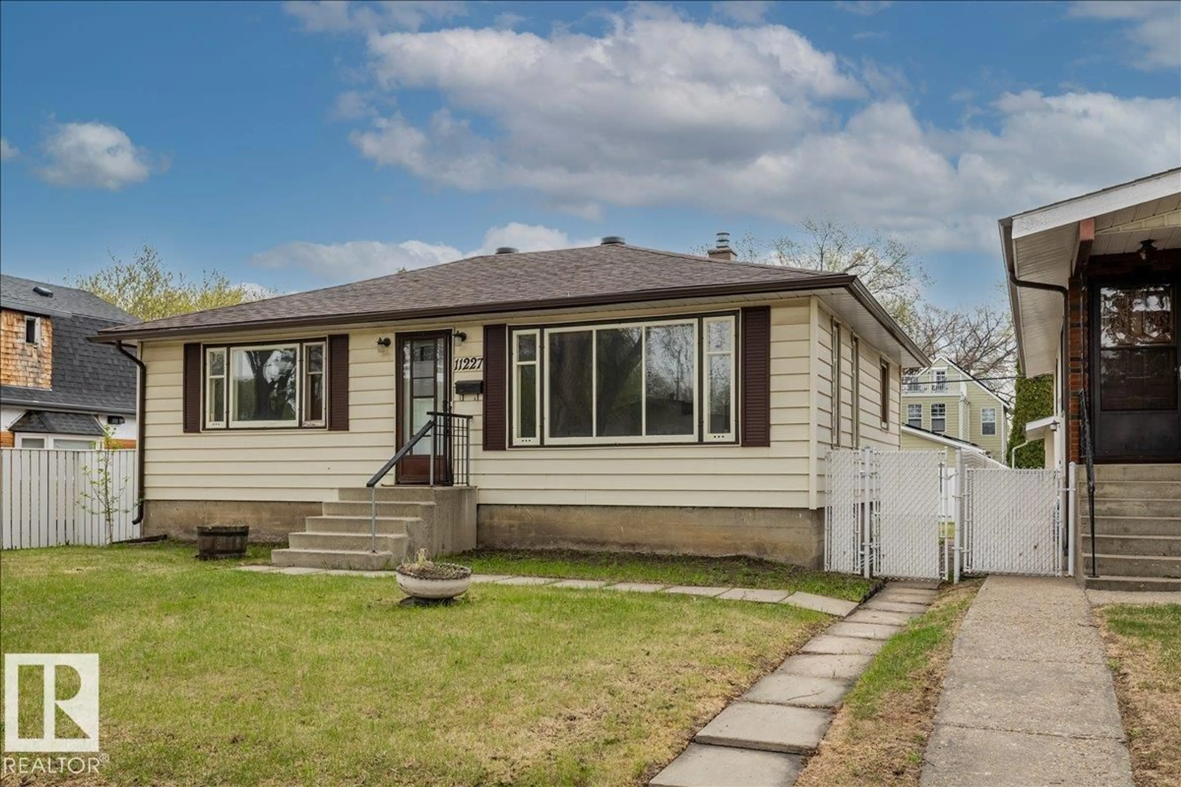 Home with vinyl exterior material, street for 11227 52 ST, Edmonton Alberta T5W3H8