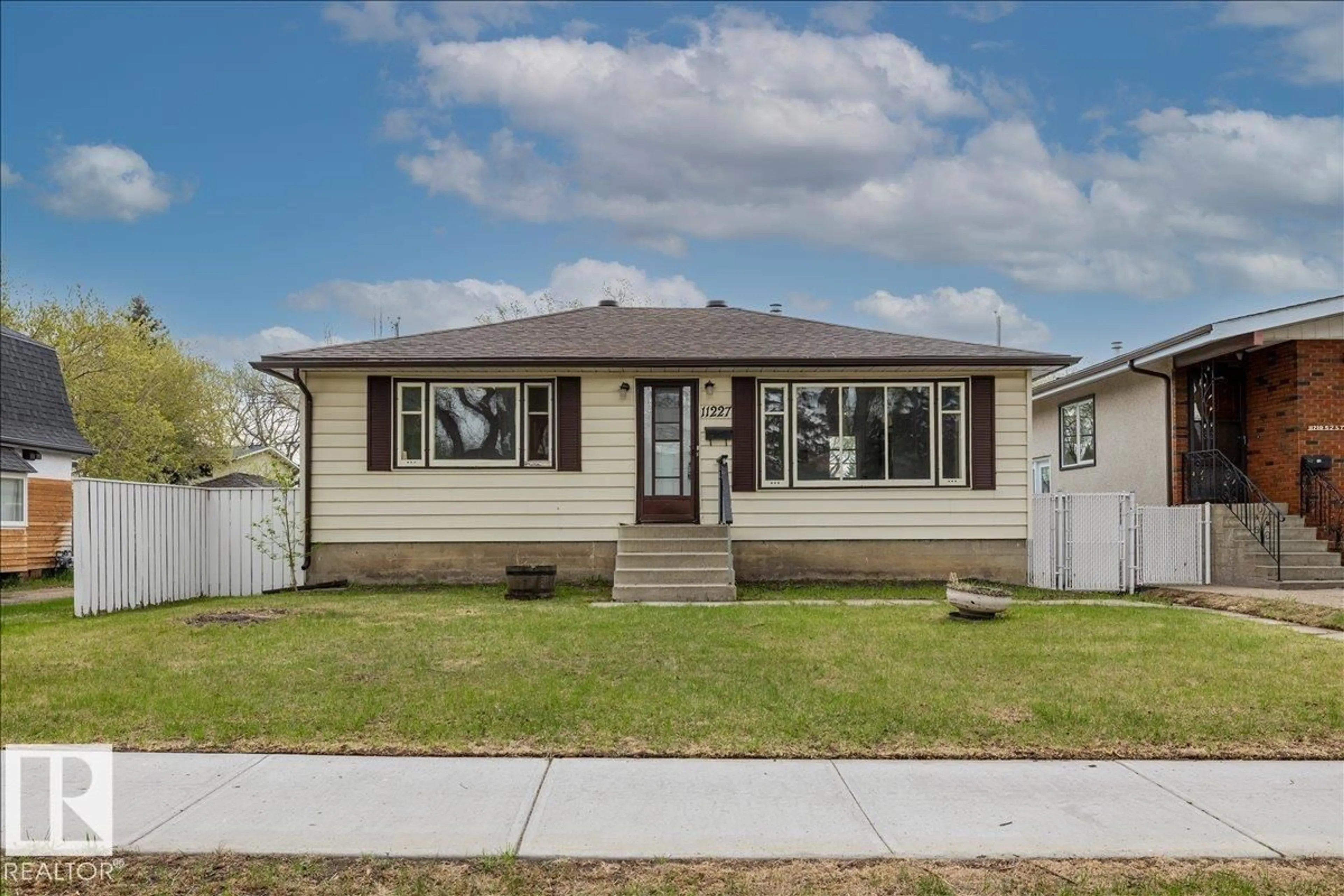 Home with vinyl exterior material, street for 11227 52 ST, Edmonton Alberta T5W3H8