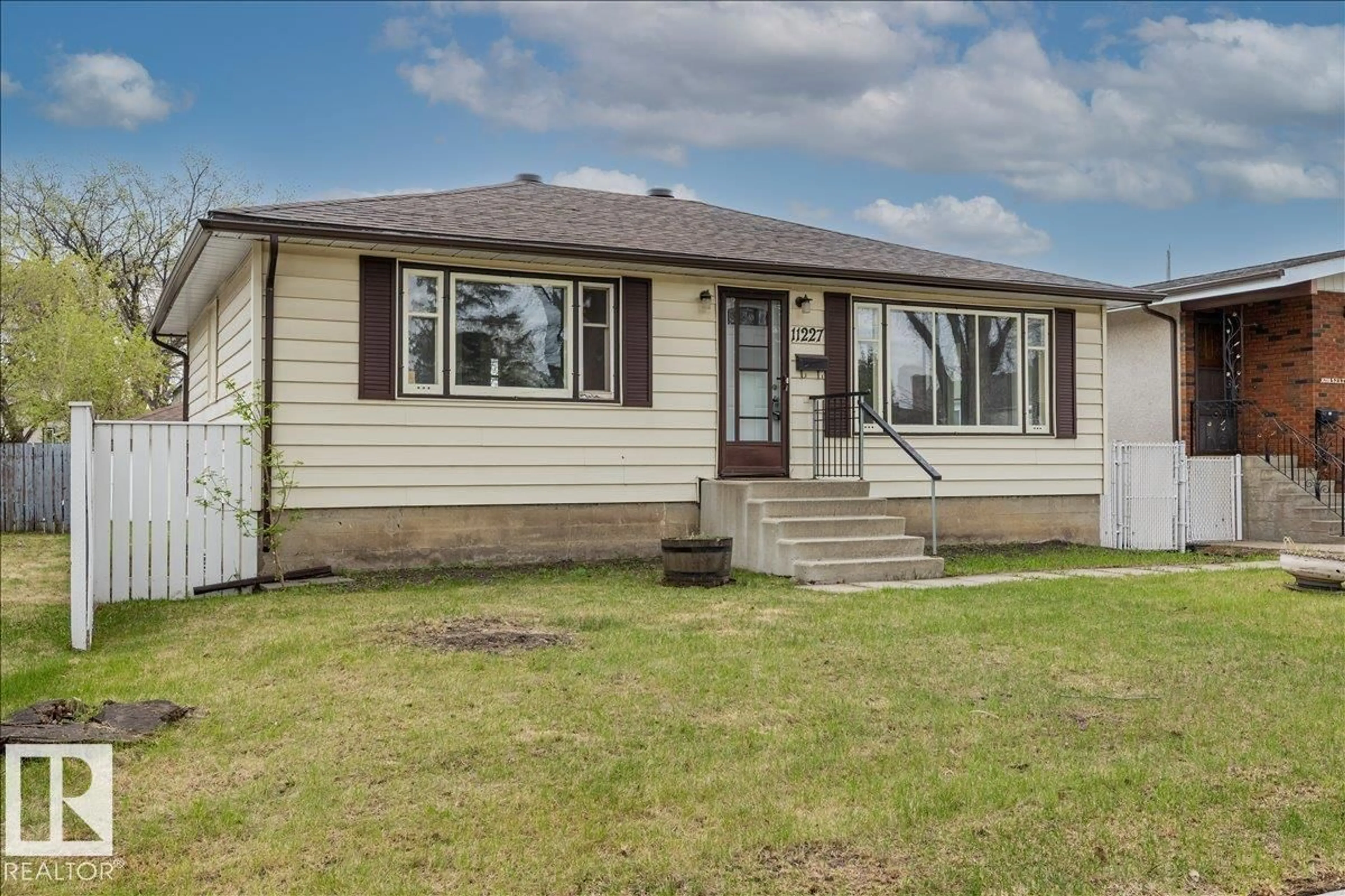 Home with vinyl exterior material, street for 11227 52 ST, Edmonton Alberta T5W3H8