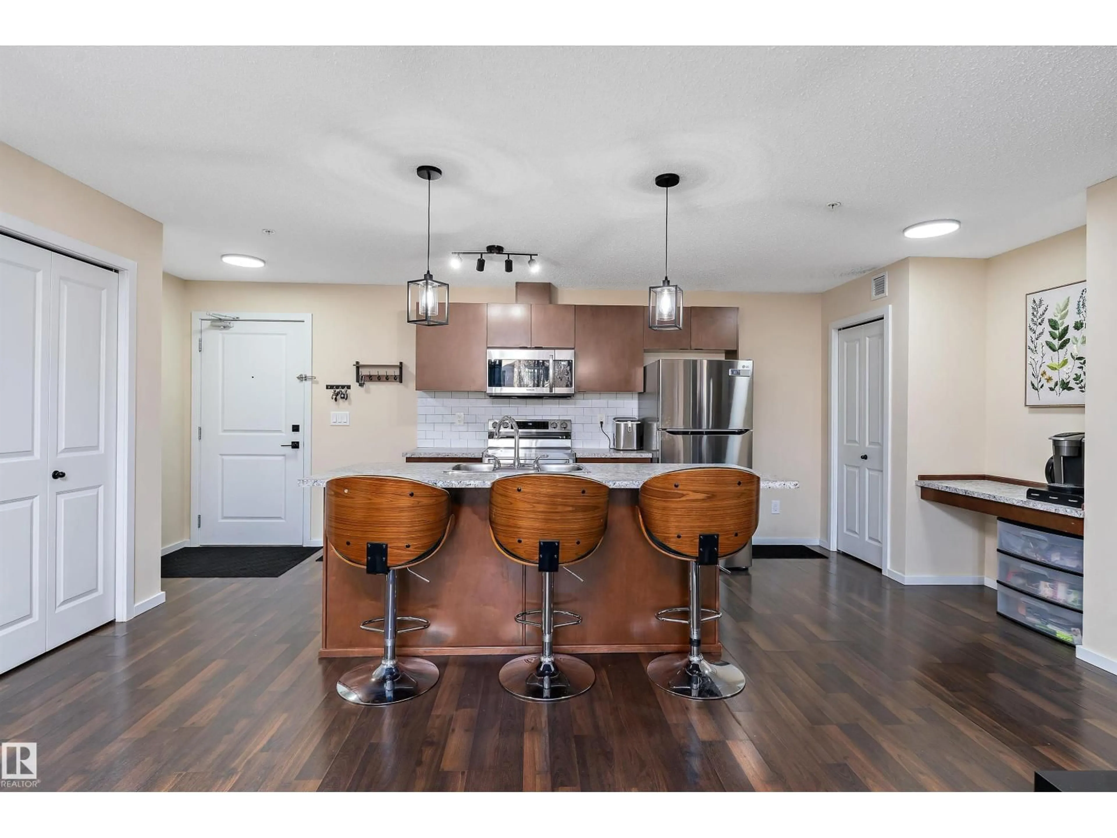 Open concept kitchen, wood/laminate floor for 122 3357 16A AVE NW, Edmonton Alberta T5T1W1