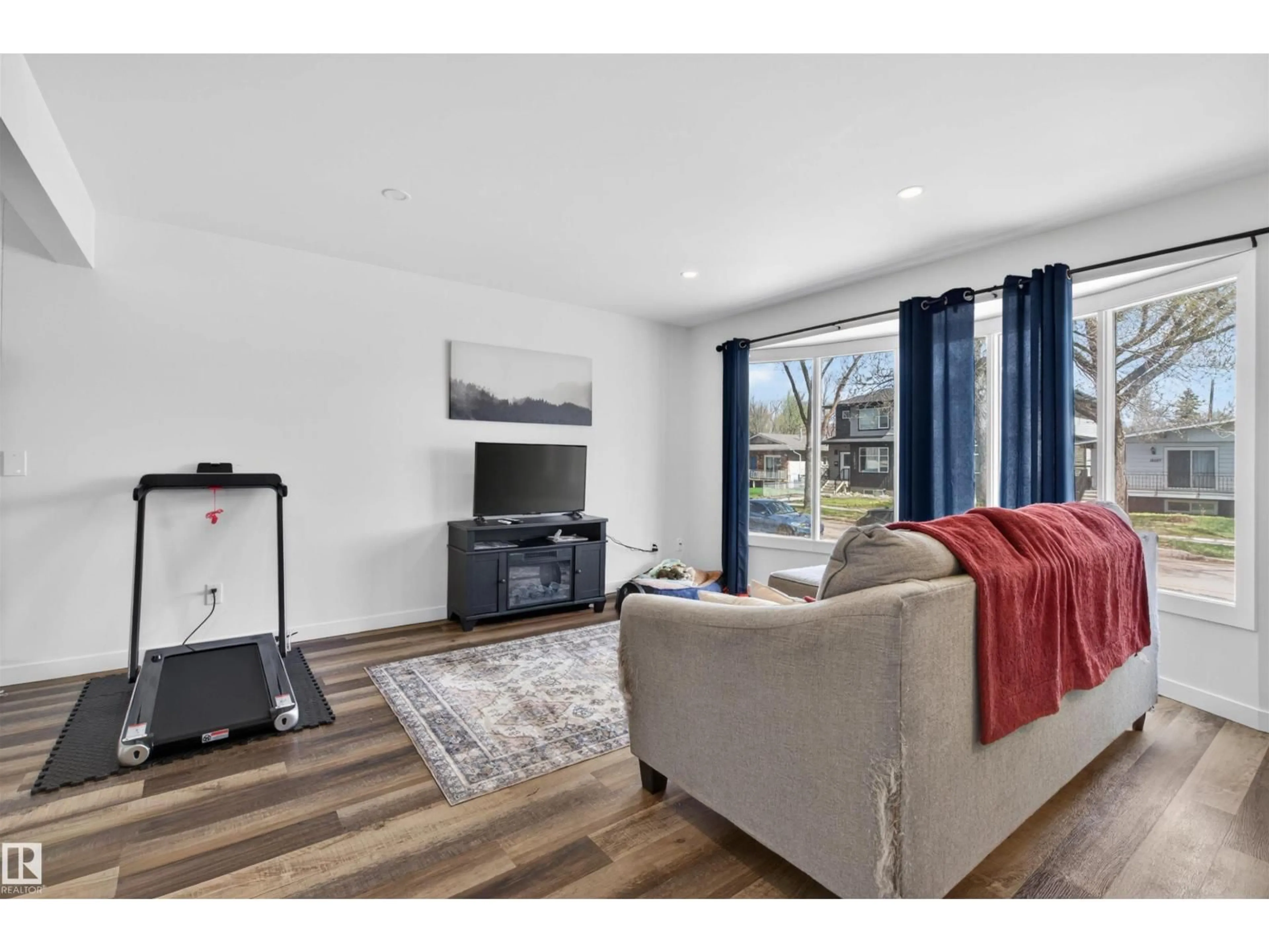 Living room with furniture, wood/laminate floor for NW - 12028-30 88 ST, Edmonton Alberta T5B3S4