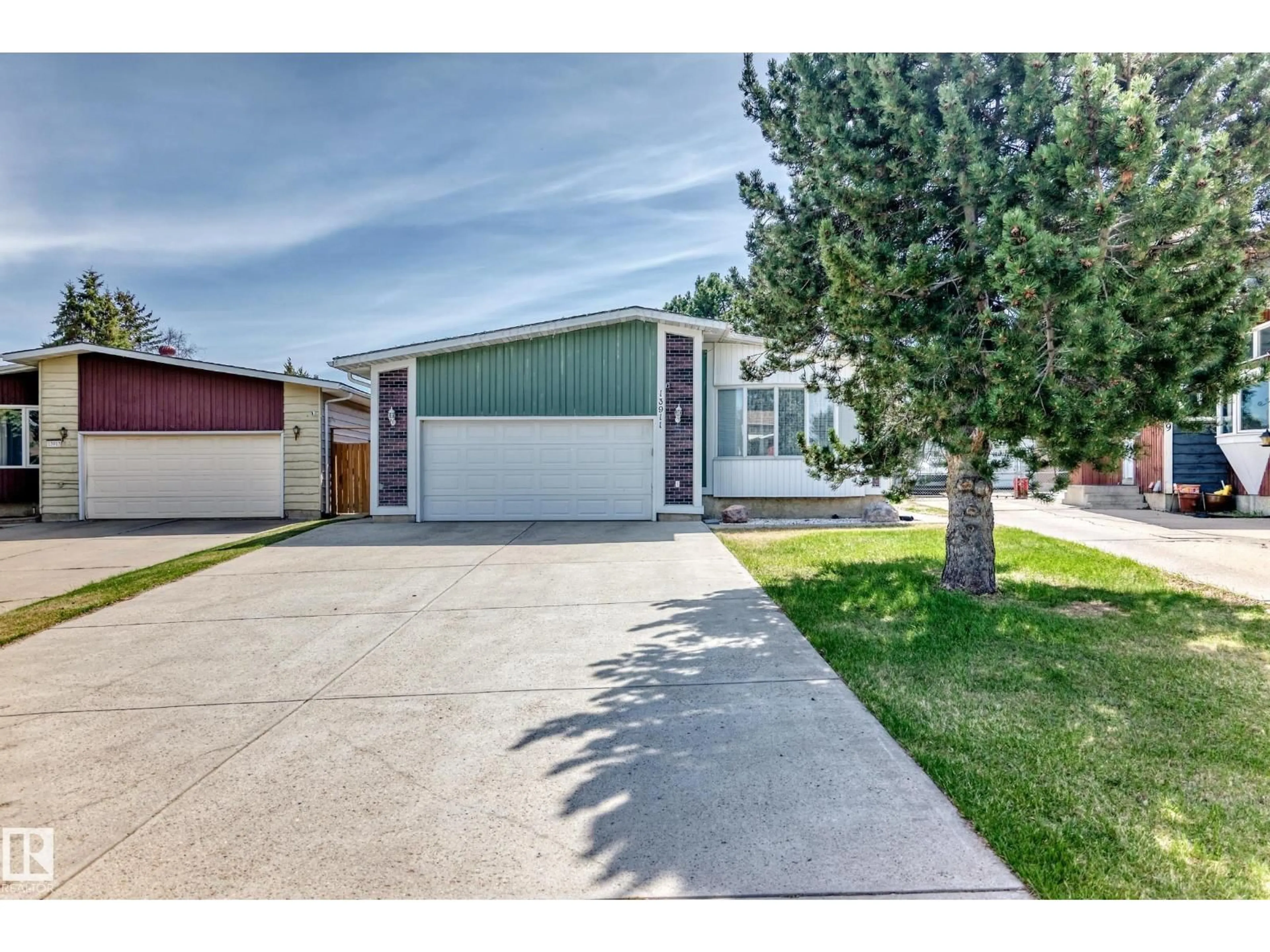 Home with vinyl exterior material, street for 13911 23 ST, Edmonton Alberta T5Y1K2