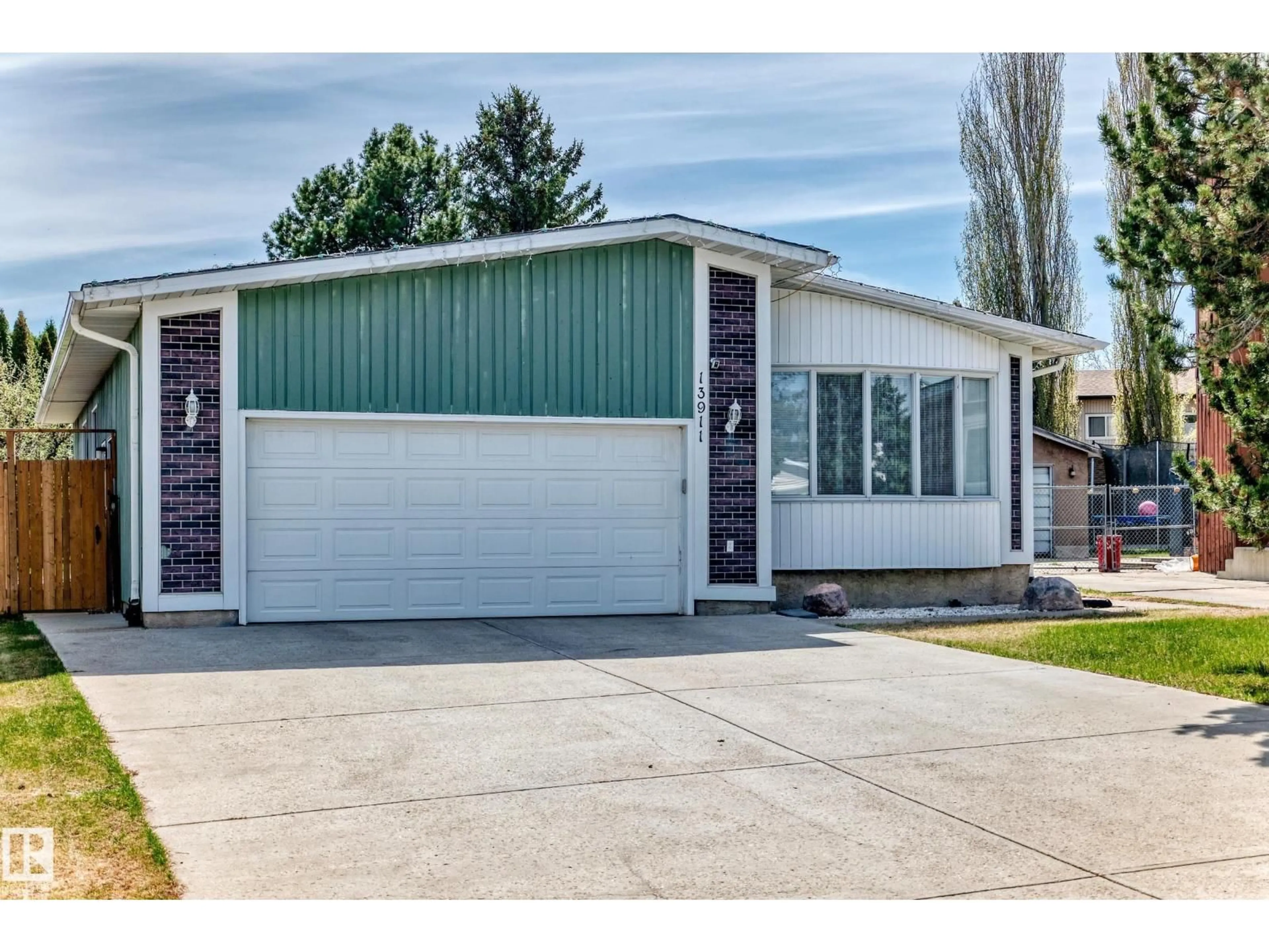Home with vinyl exterior material, street for 13911 23 ST, Edmonton Alberta T5Y1K2