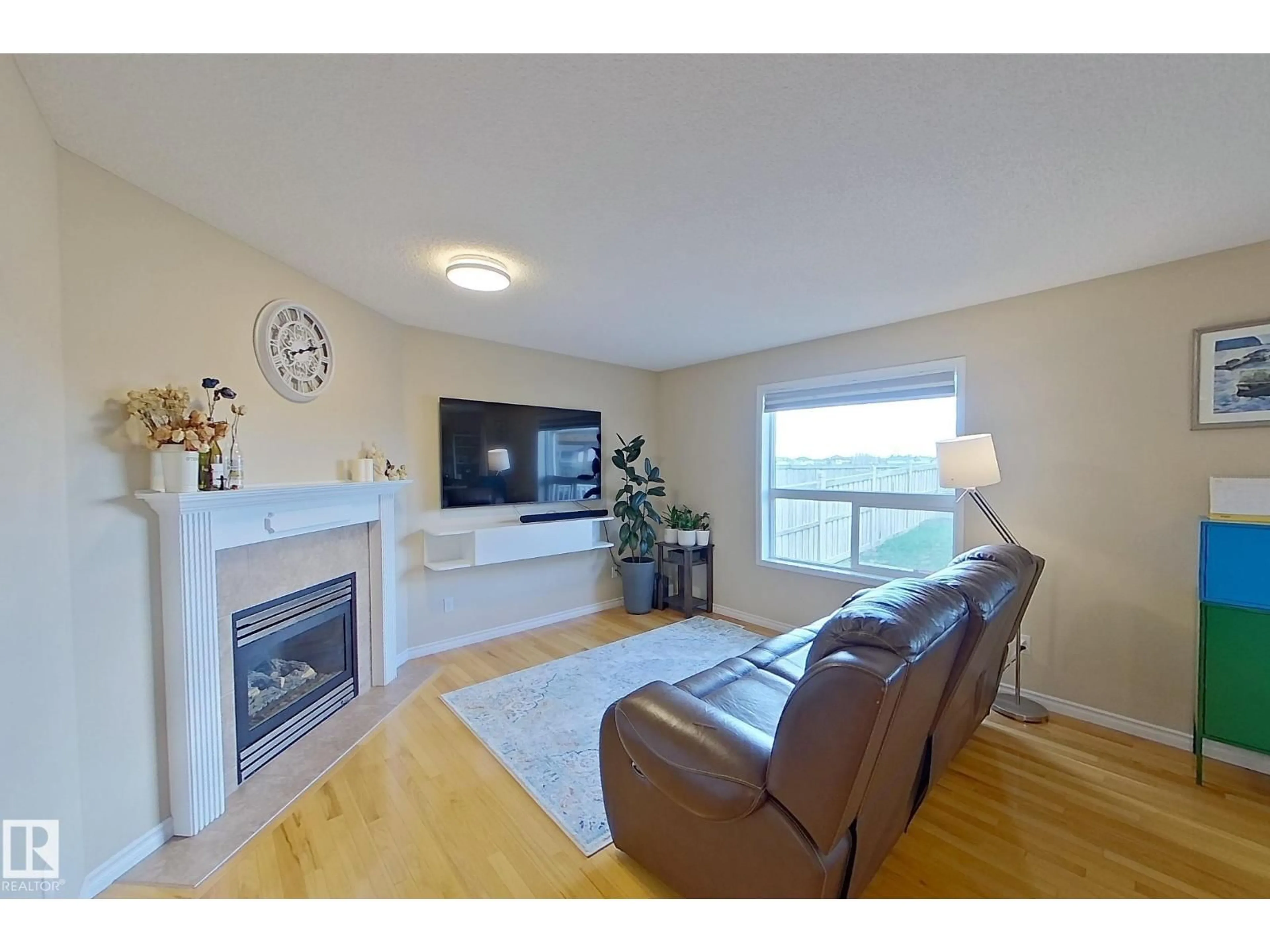 Living room with furniture, wood/laminate floor for 3540 MCLEAN CR, Edmonton Alberta T6W1M3