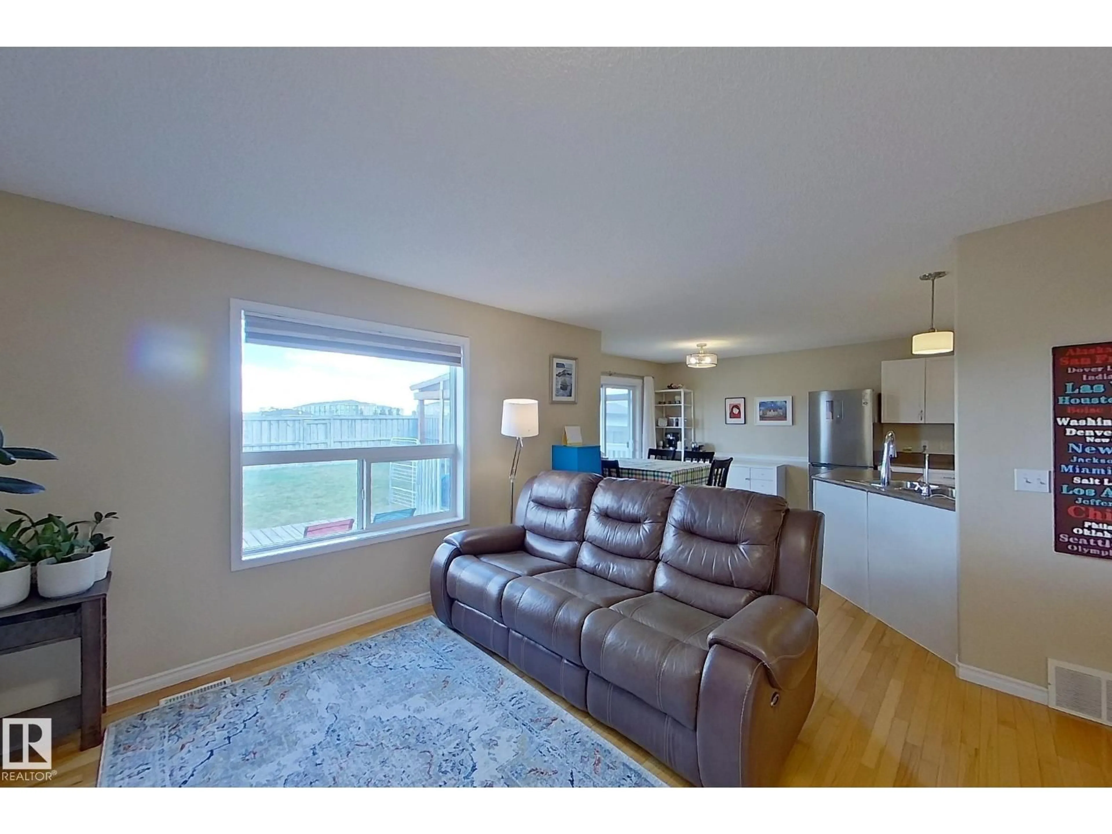 Living room with furniture, wood/laminate floor for 3540 MCLEAN CR, Edmonton Alberta T6W1M3