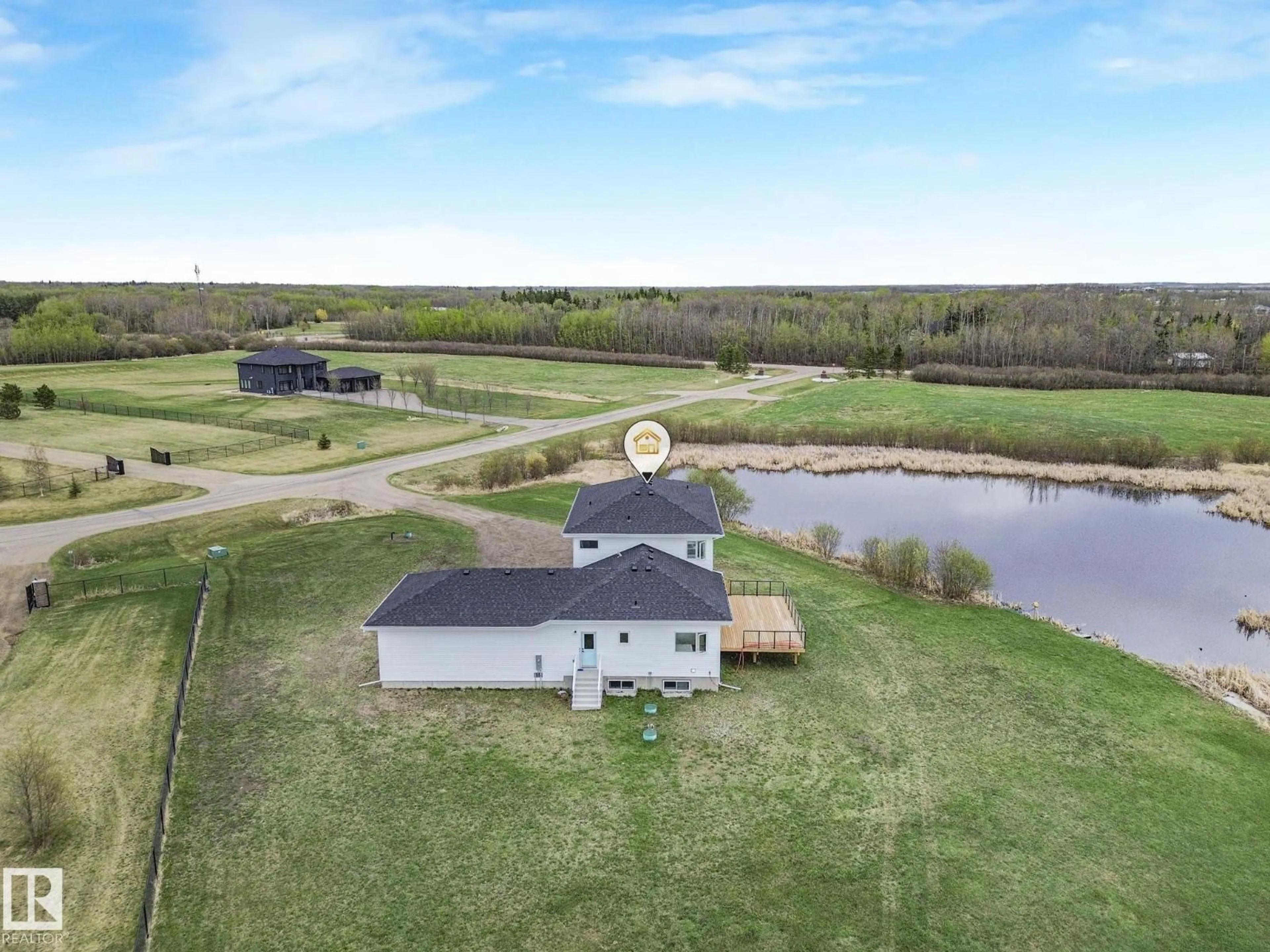 A pic from outside/outdoor area/front of a property/back of a property/a pic from drone, water/lake/river/ocean view for 60 23412 TWP RD 505, Rural Leduc County Alberta T4X0S1
