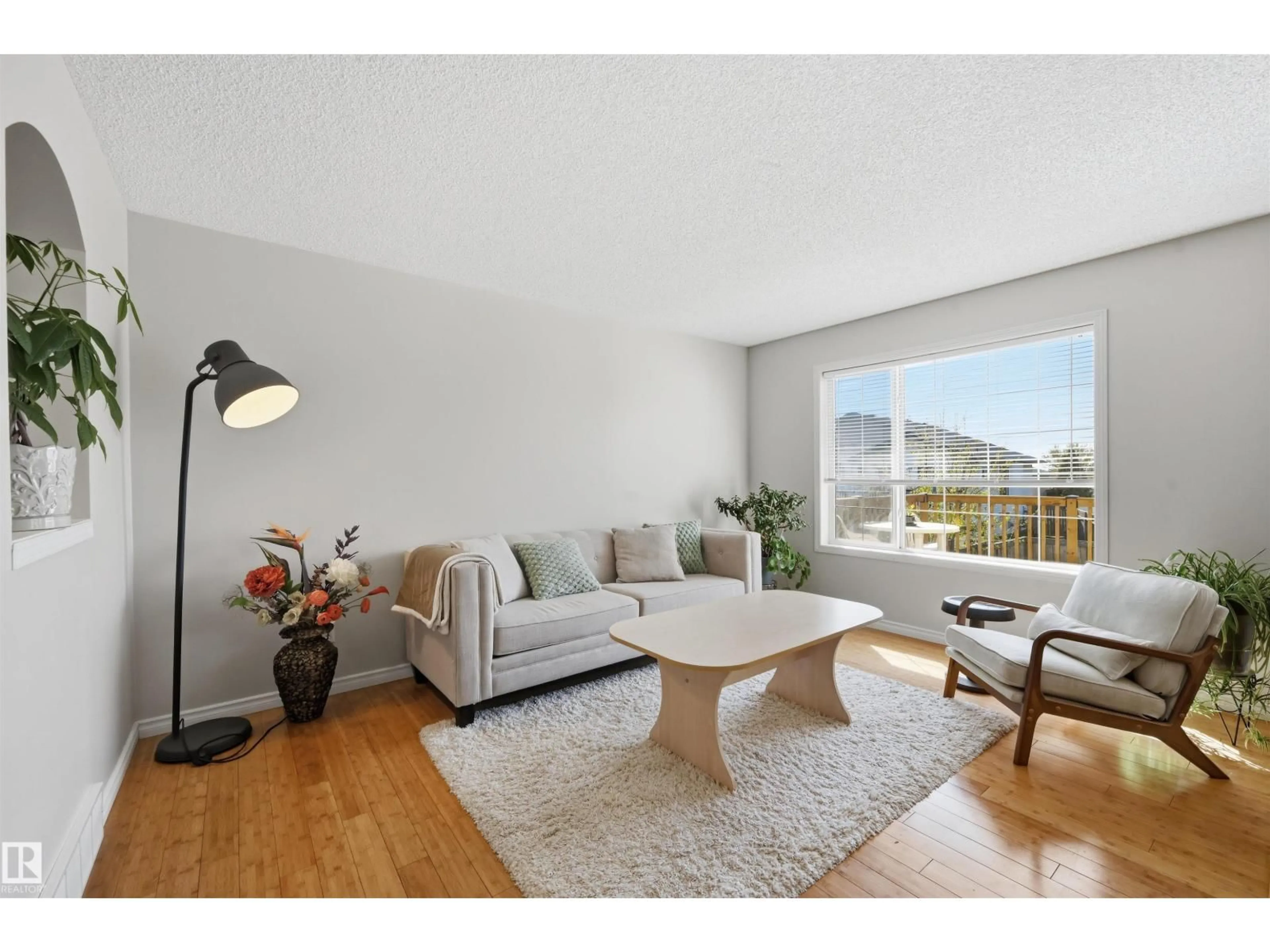Living room with furniture, wood/laminate floor for NW - 4831 147 AV, Edmonton Alberta T5Y2X2
