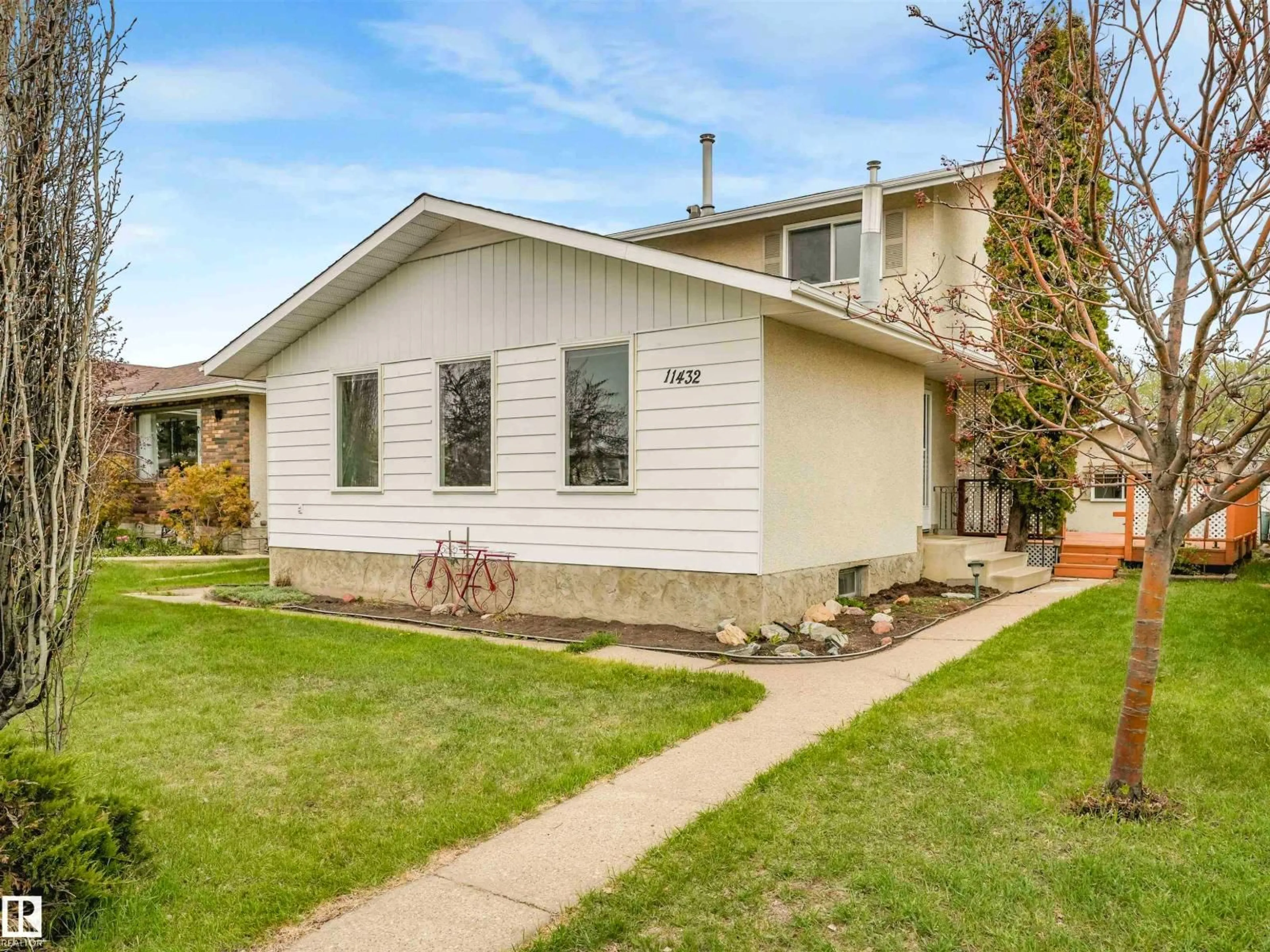 Home with vinyl exterior material, street for 11432 144 AV, Edmonton Alberta T5X1L8