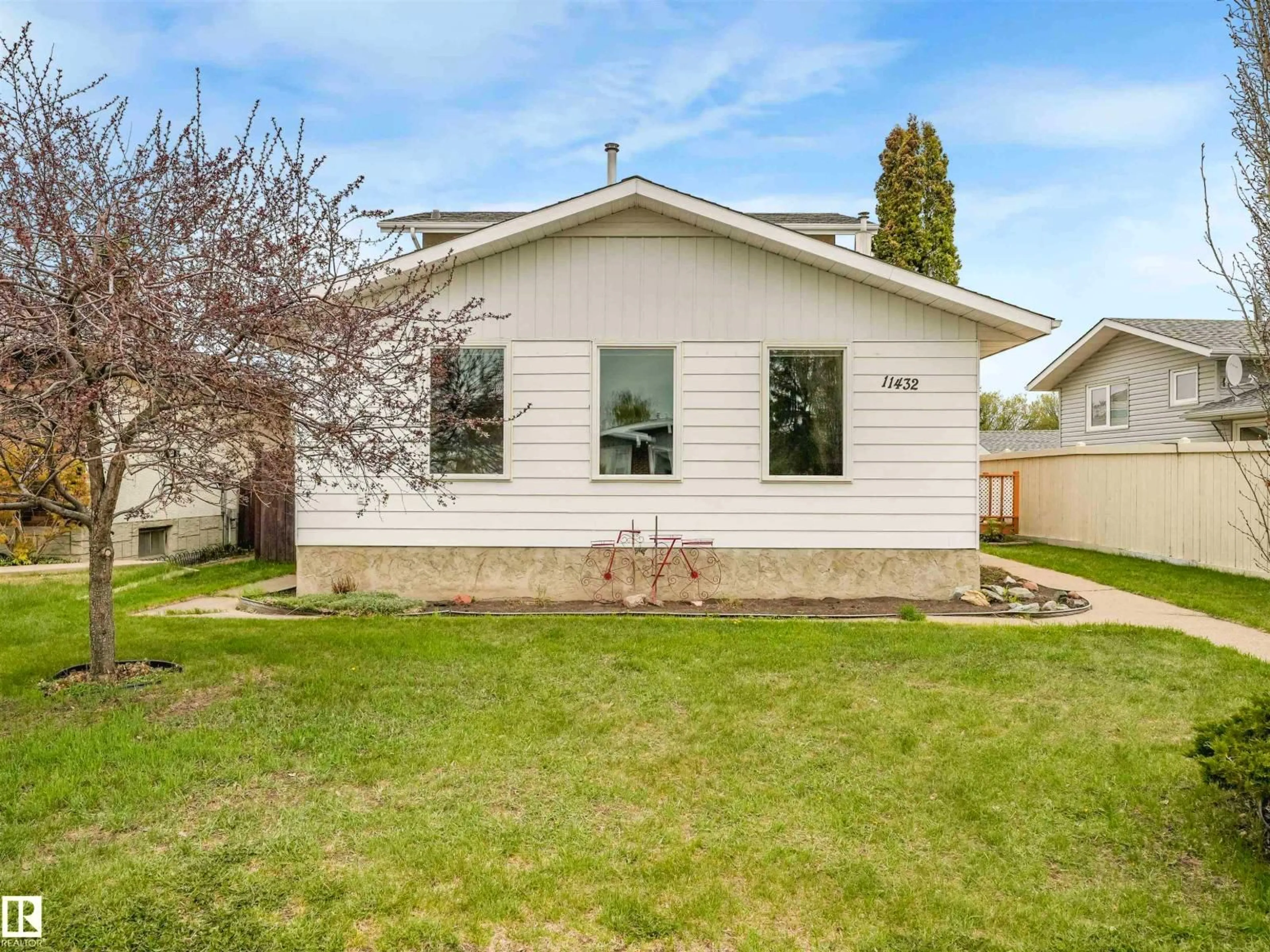 Home with vinyl exterior material, street for 11432 144 AV, Edmonton Alberta T5X1L8