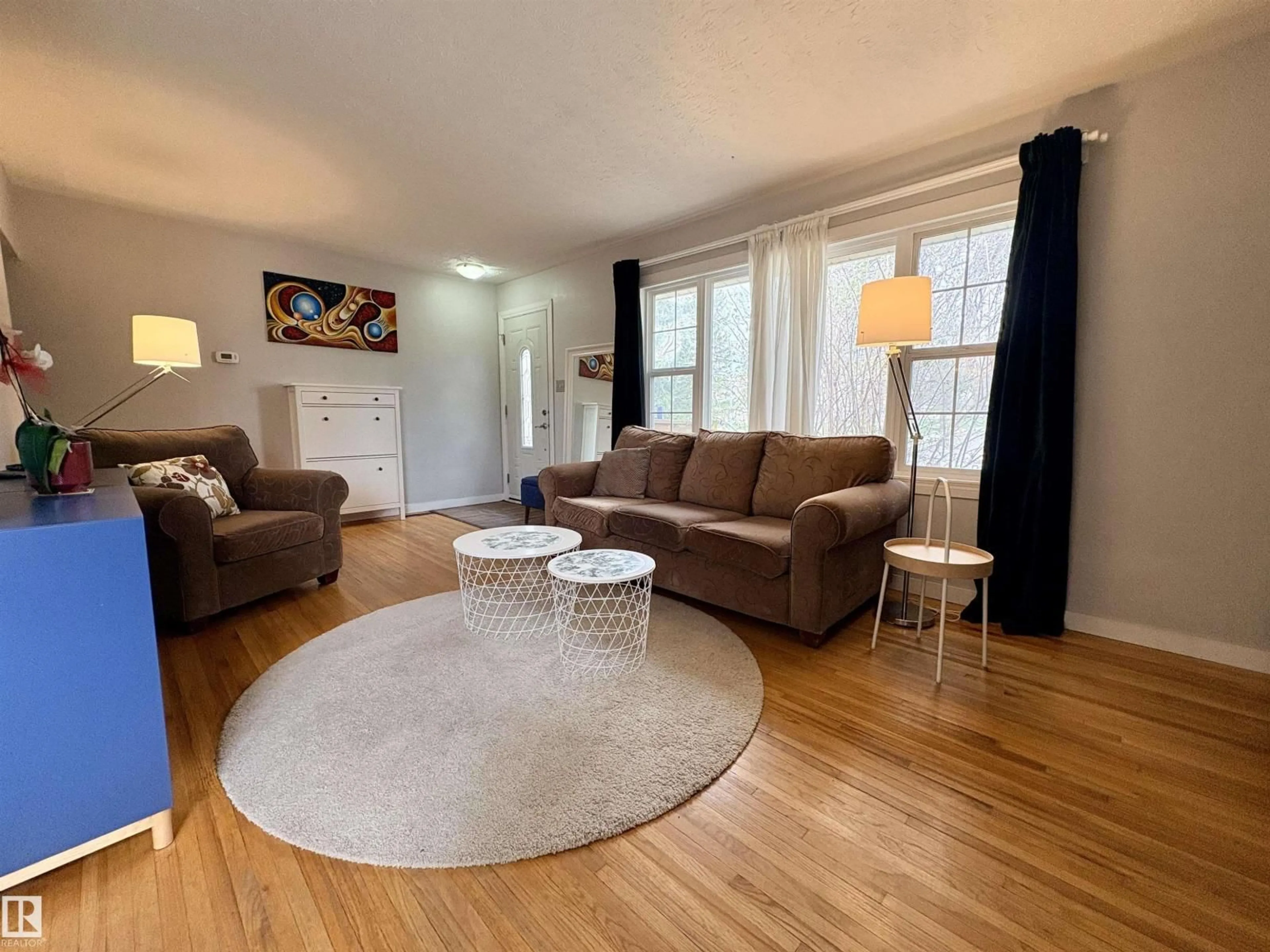Living room with furniture, wood/laminate floor for 9103 131 AV, Edmonton Alberta T5E0W1