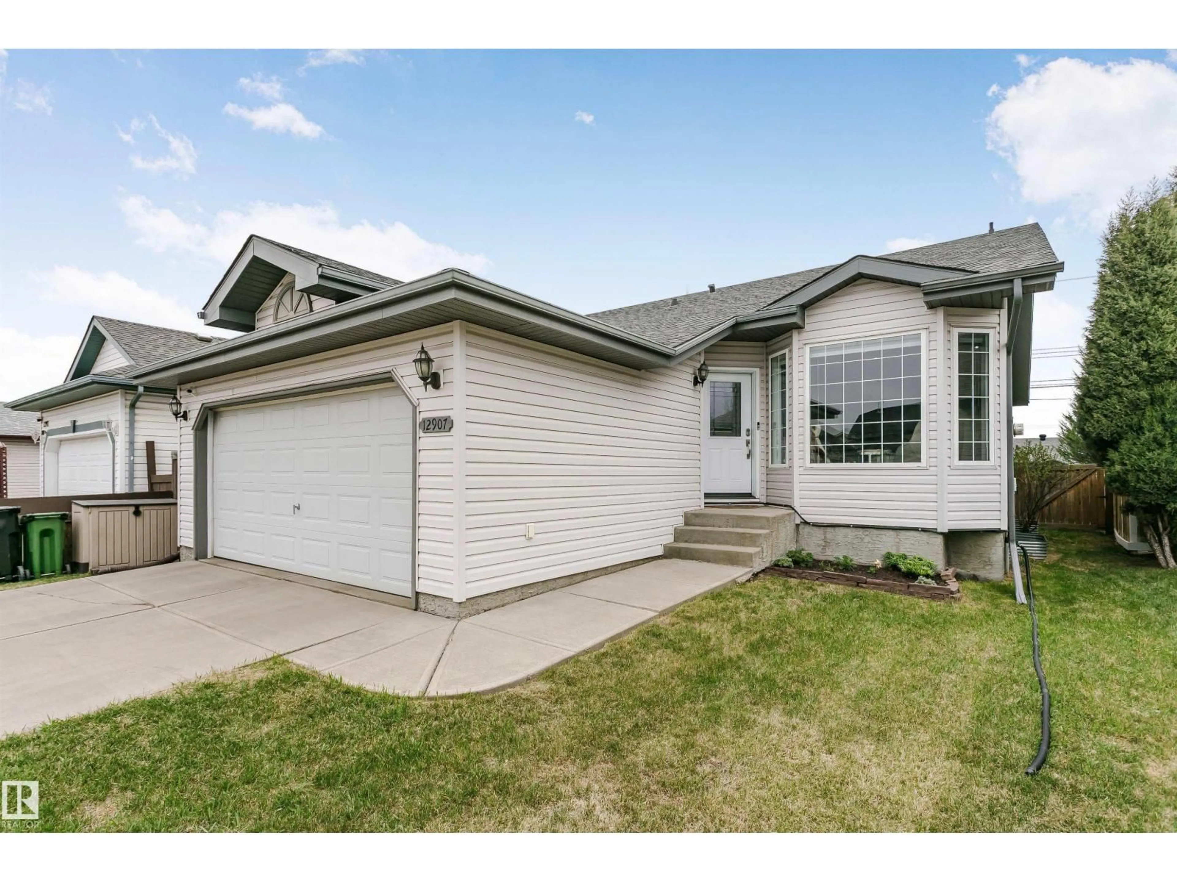 Home with vinyl exterior material, street for 12907 136 ST, Edmonton Alberta T5L5C8