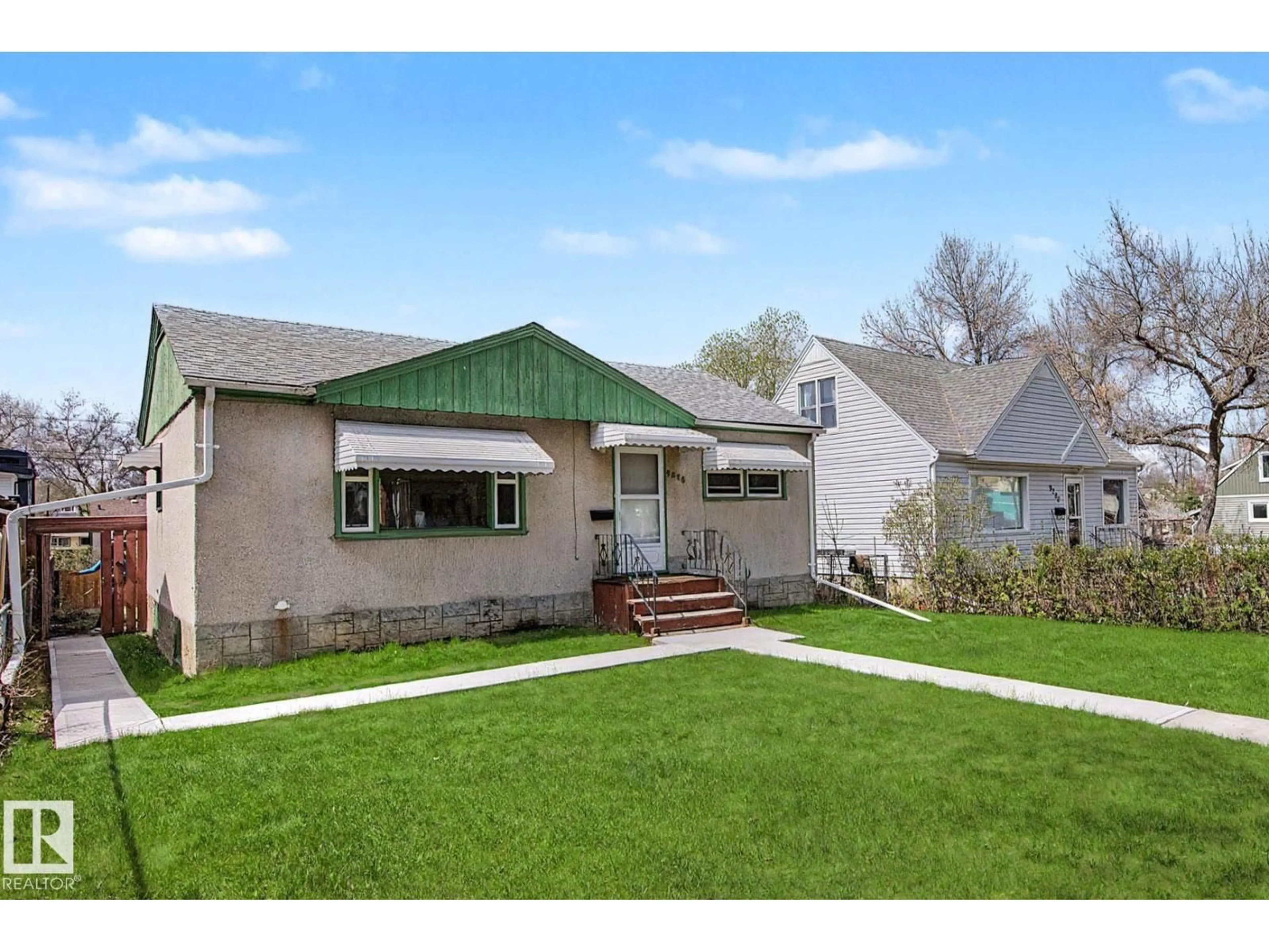 Home with vinyl exterior material, street for NW - 9276 86 ST, Edmonton Alberta T6C3E4