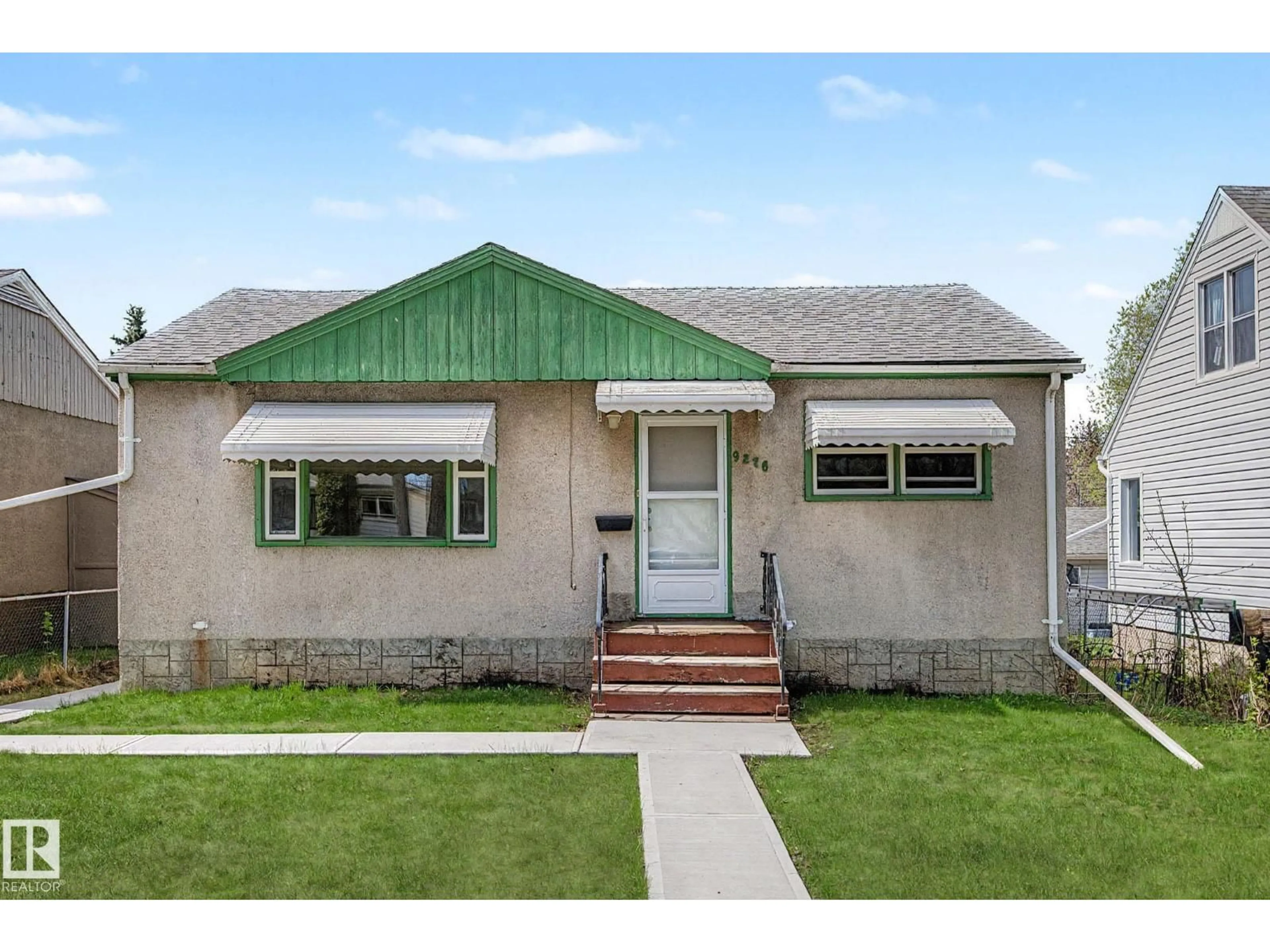 Home with vinyl exterior material, street for NW - 9276 86 ST, Edmonton Alberta T6C3E4