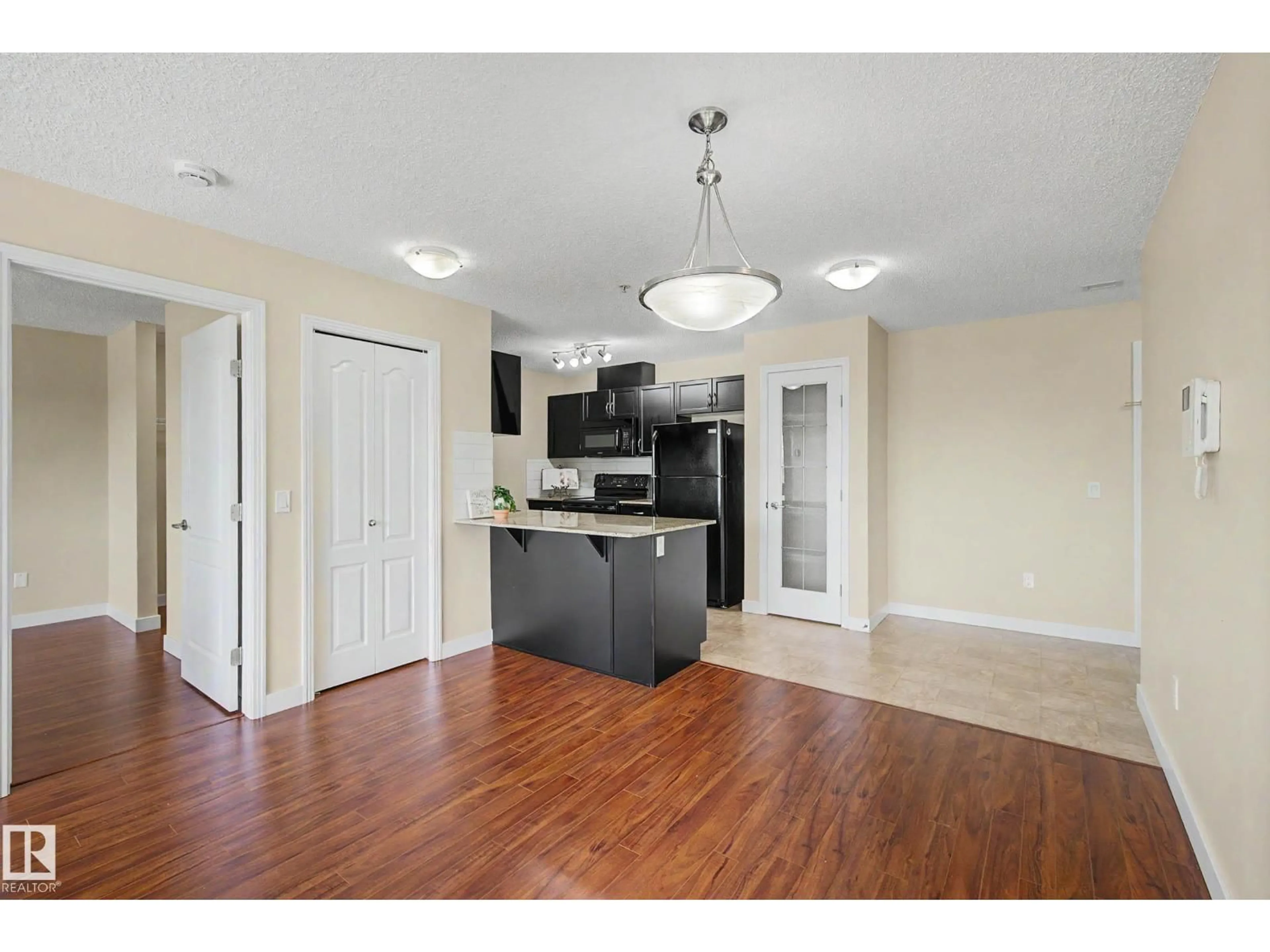 Open concept kitchen, wood/laminate floor for #217 - 12650 142 AV, Edmonton Alberta T5X0J4