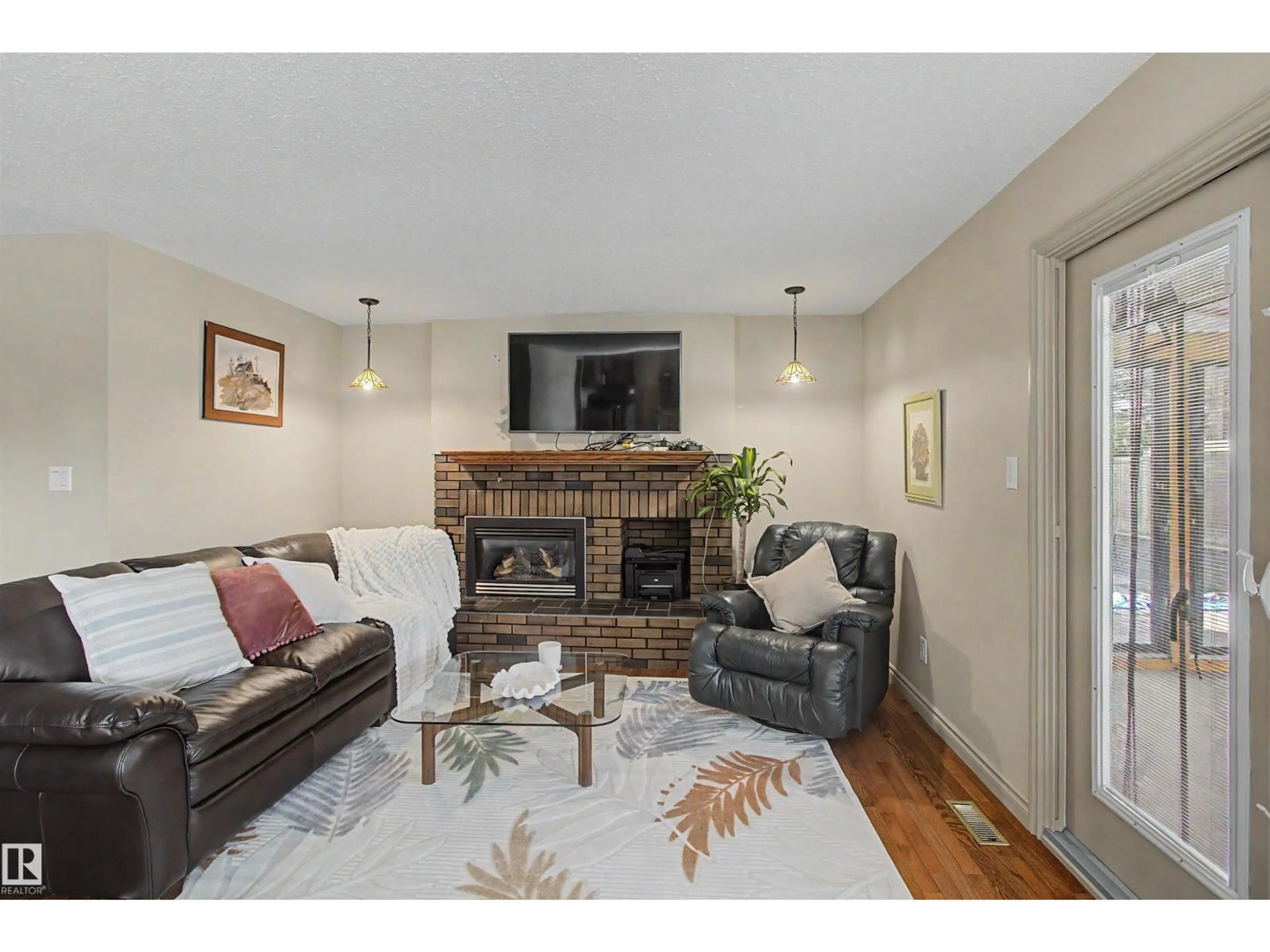 Living room with furniture, wood/laminate floor for 11617 26 AV, Edmonton Alberta T6J3R3