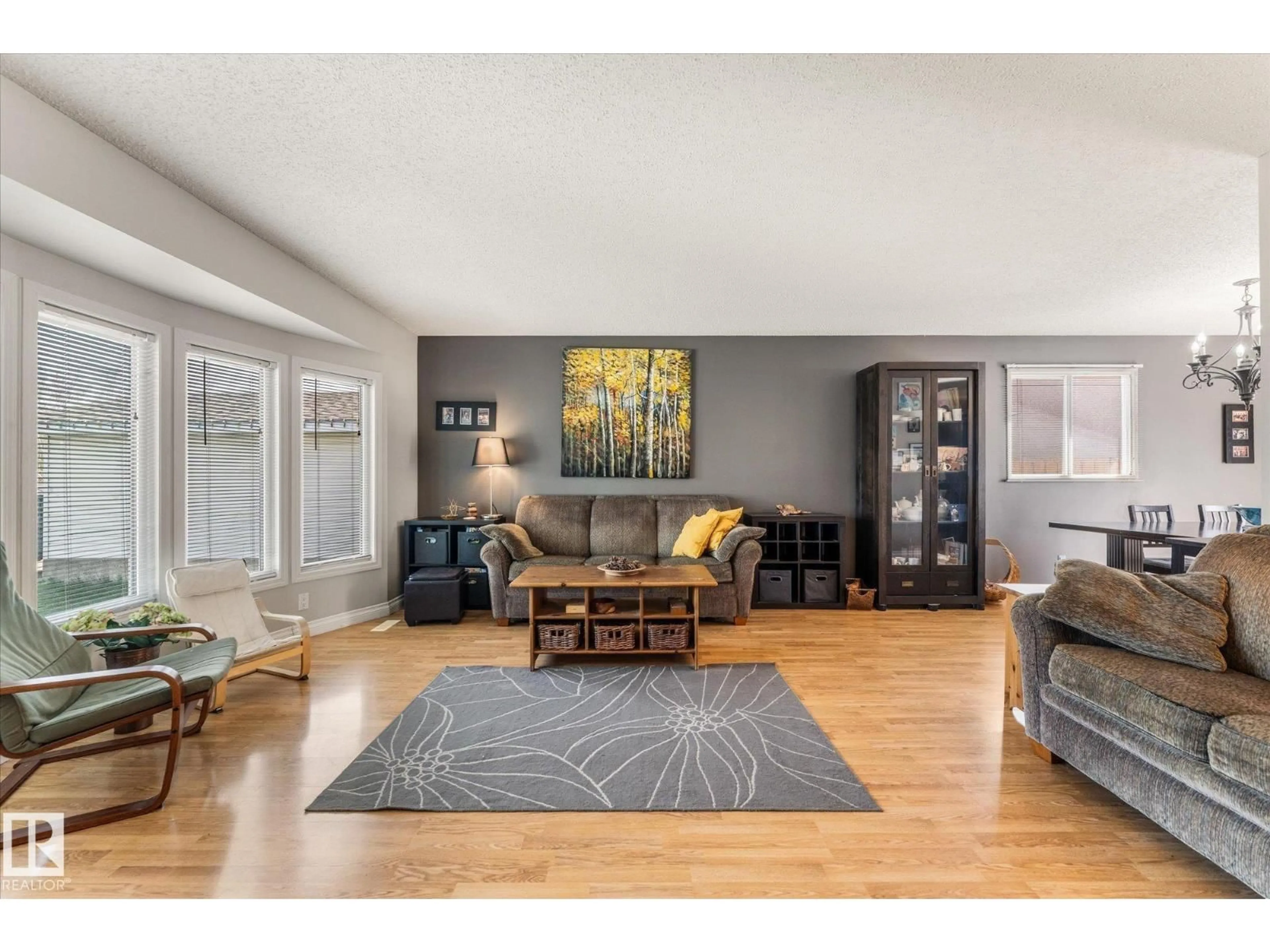 Living room with furniture, wood/laminate floor for 4627 10A AV, Edmonton Alberta T6L4E4