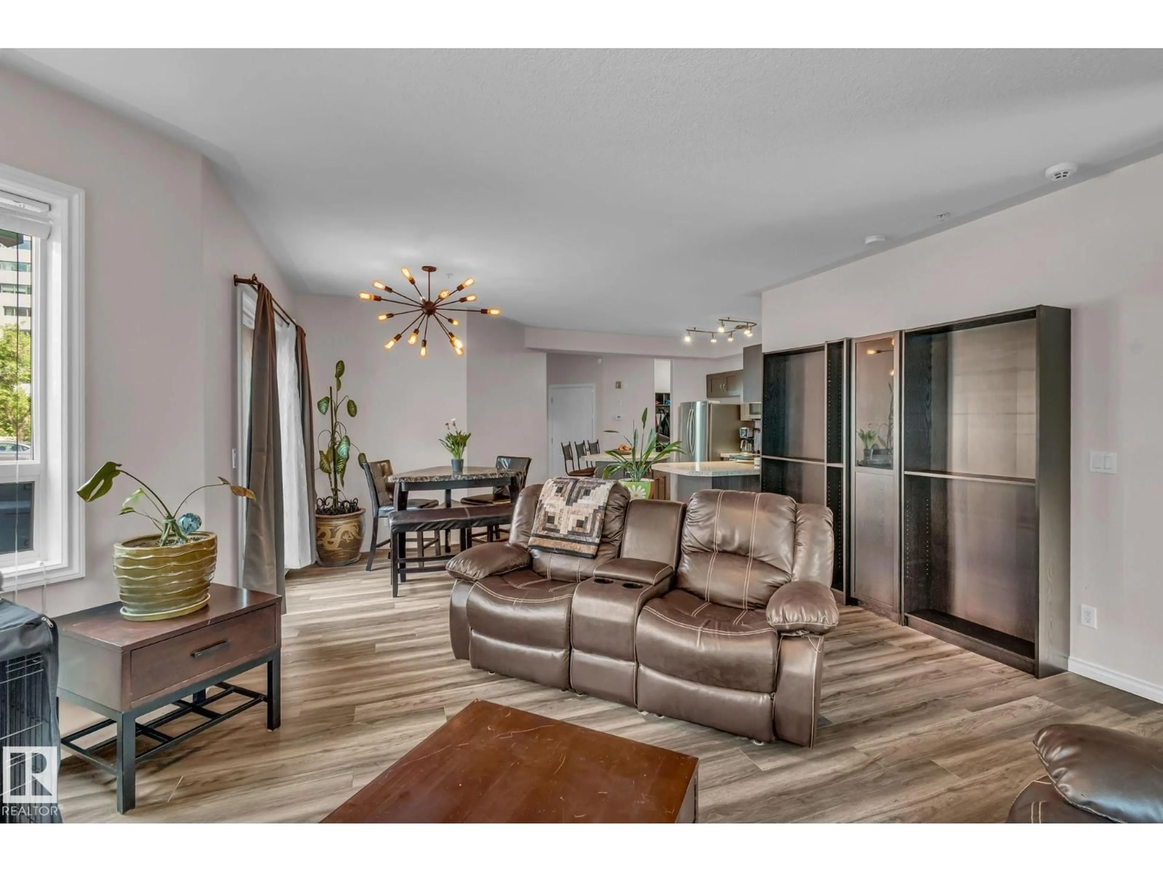 Living room with furniture, wood/laminate floor for #104 - 10046 110 ST NW, Edmonton Alberta T5K2Y2