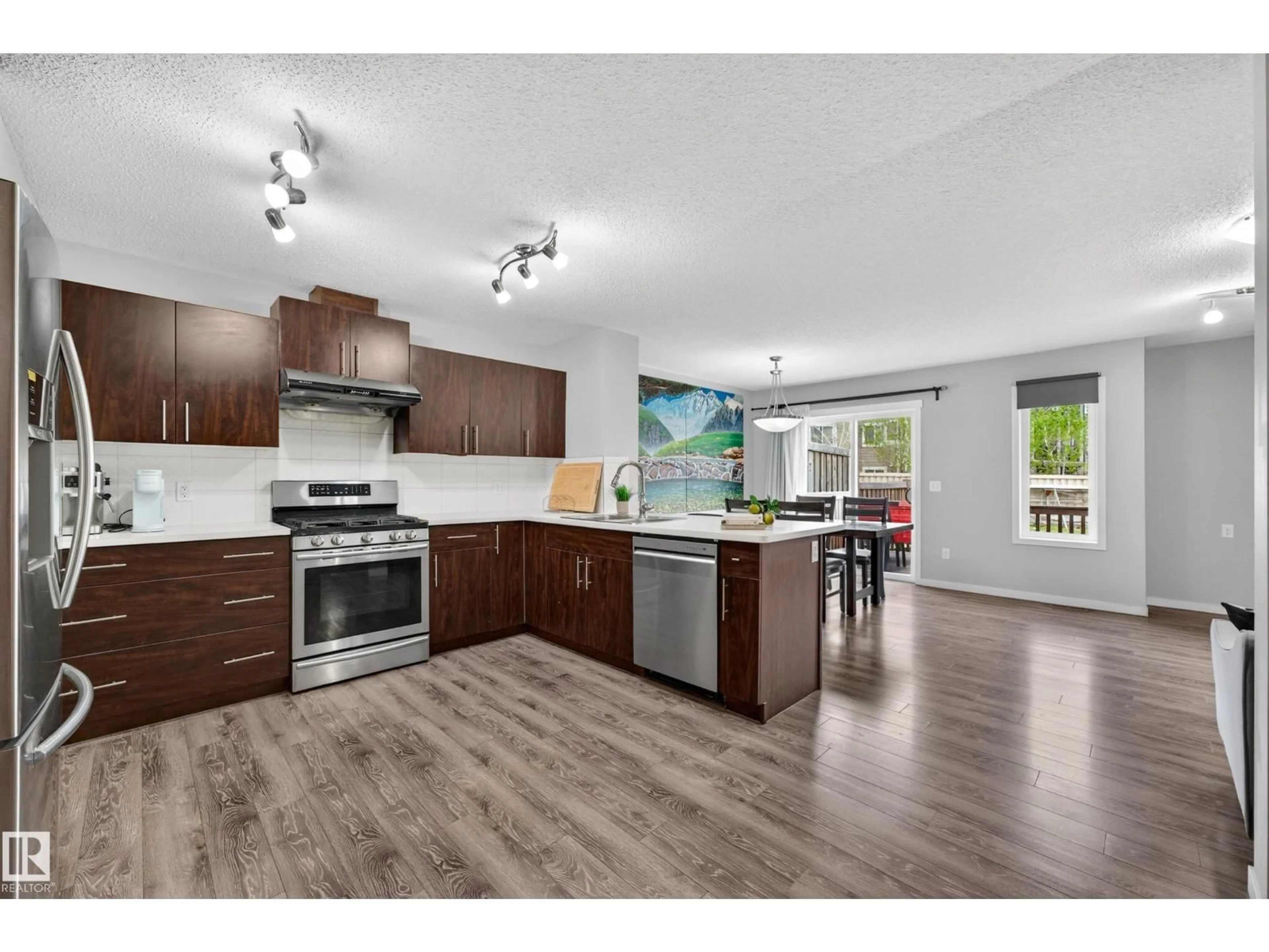 Open concept kitchen, wood/laminate floor for SW - 4371 ANNETT CM, Edmonton Alberta T6W2V6