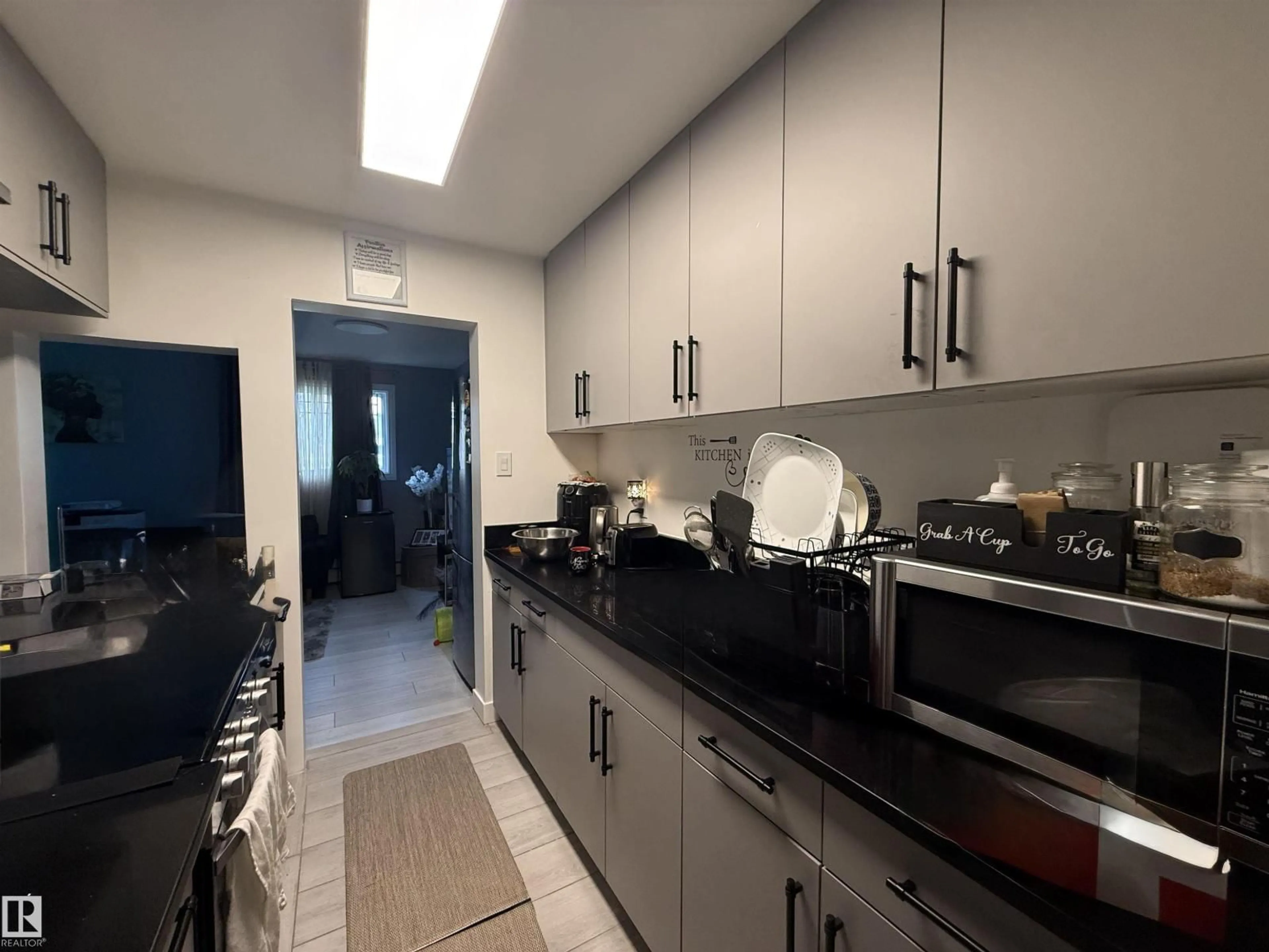 Kitchen with laundary machines, ceramic/tile floor for #102 - 12409 82 ST, Edmonton Alberta T5B2X5